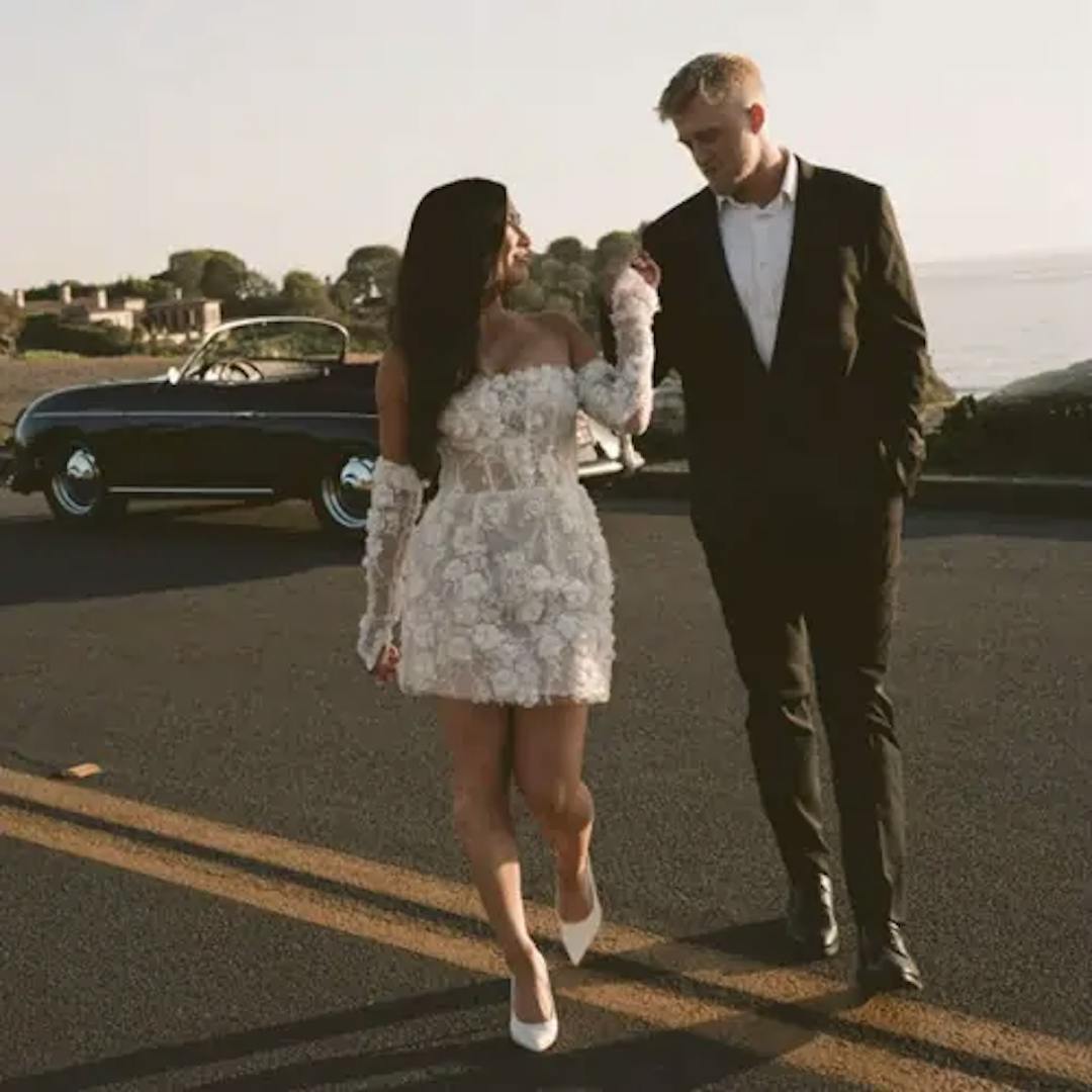 Bride and groom walking across the street.