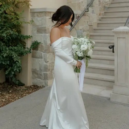 Bride standing with bouquet.