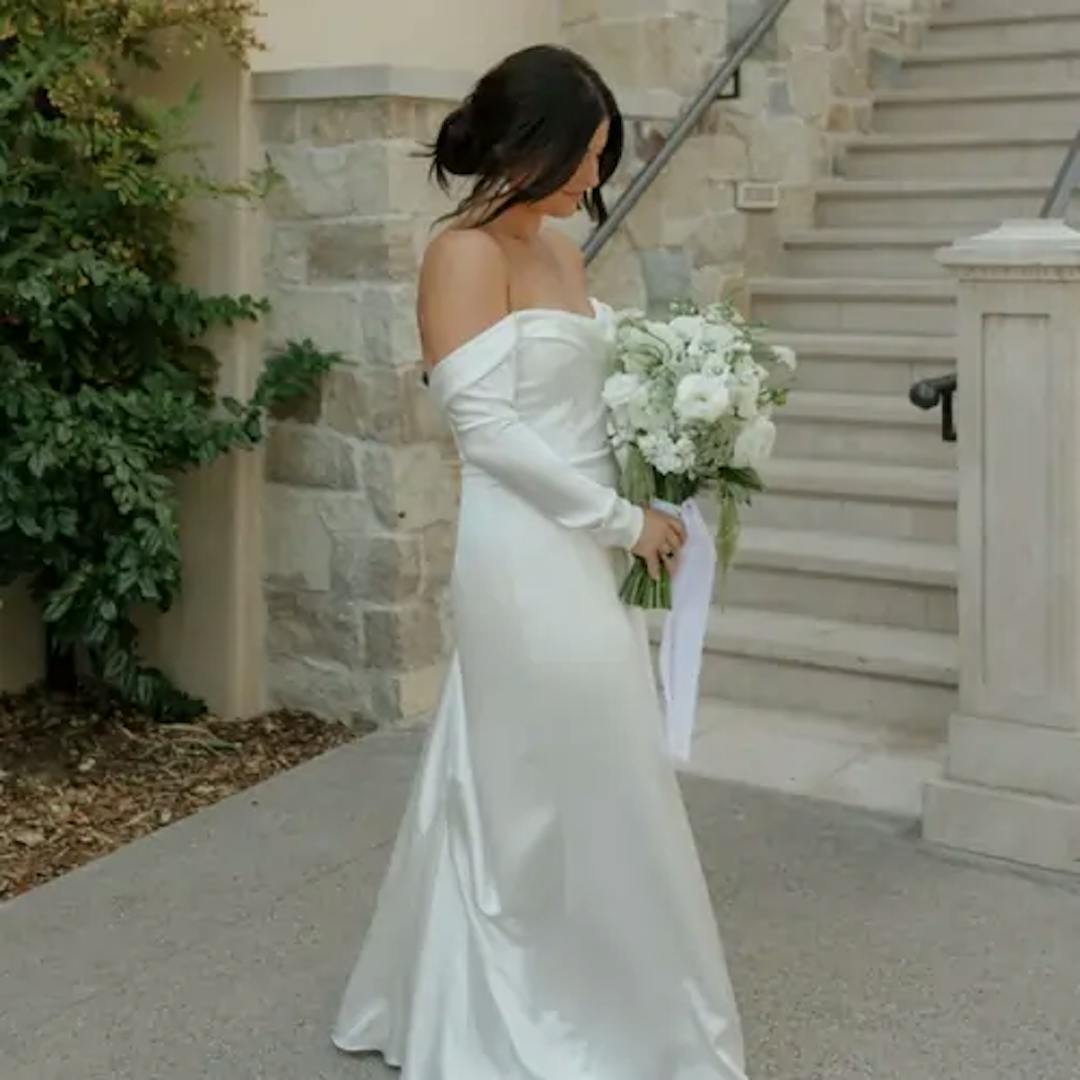 Bride standing with bouquet.