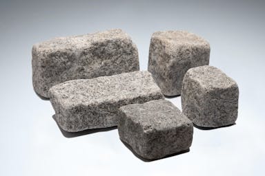 Five sizes of medium grey tumbled granite setts