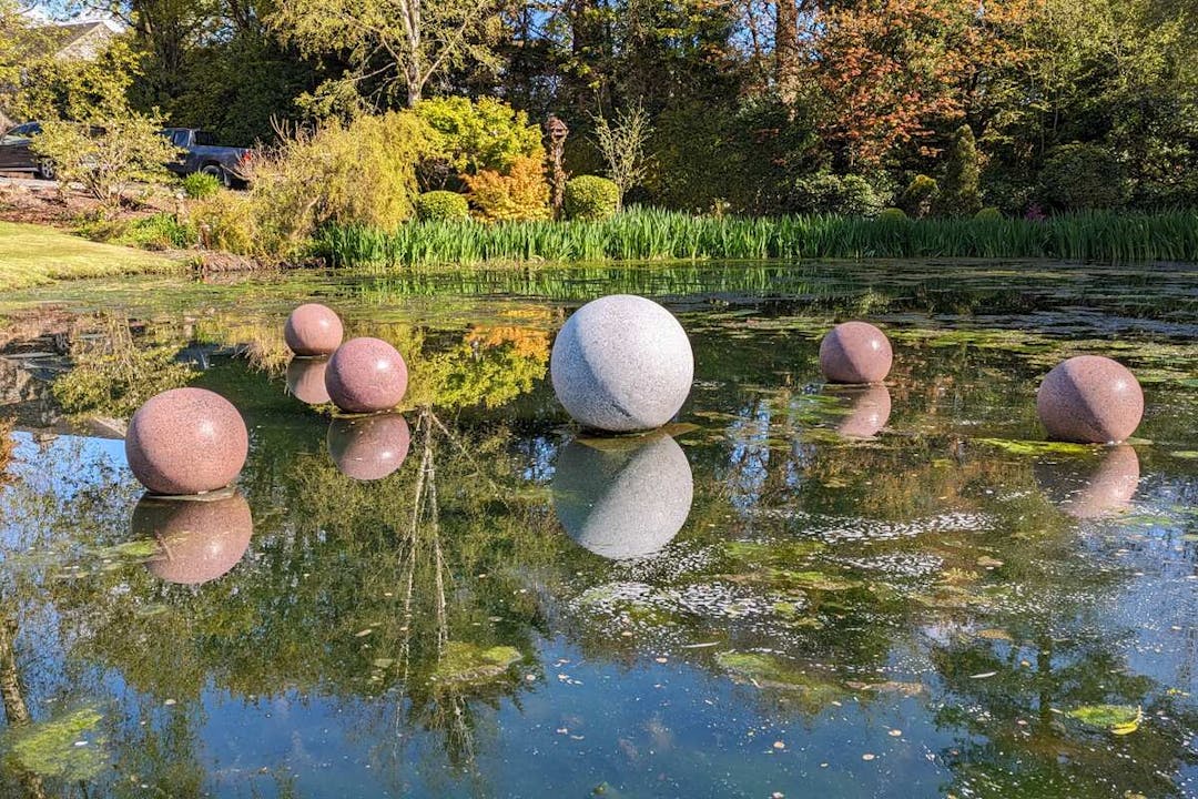 Granite spheres positioned on a pond