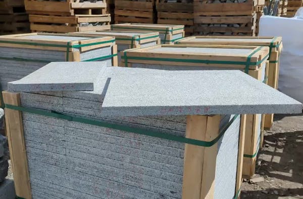 Pack of granite paving slabs in wooden crate