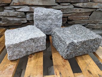 Large oversized 200x200x100mm granite setts on a wooden palette