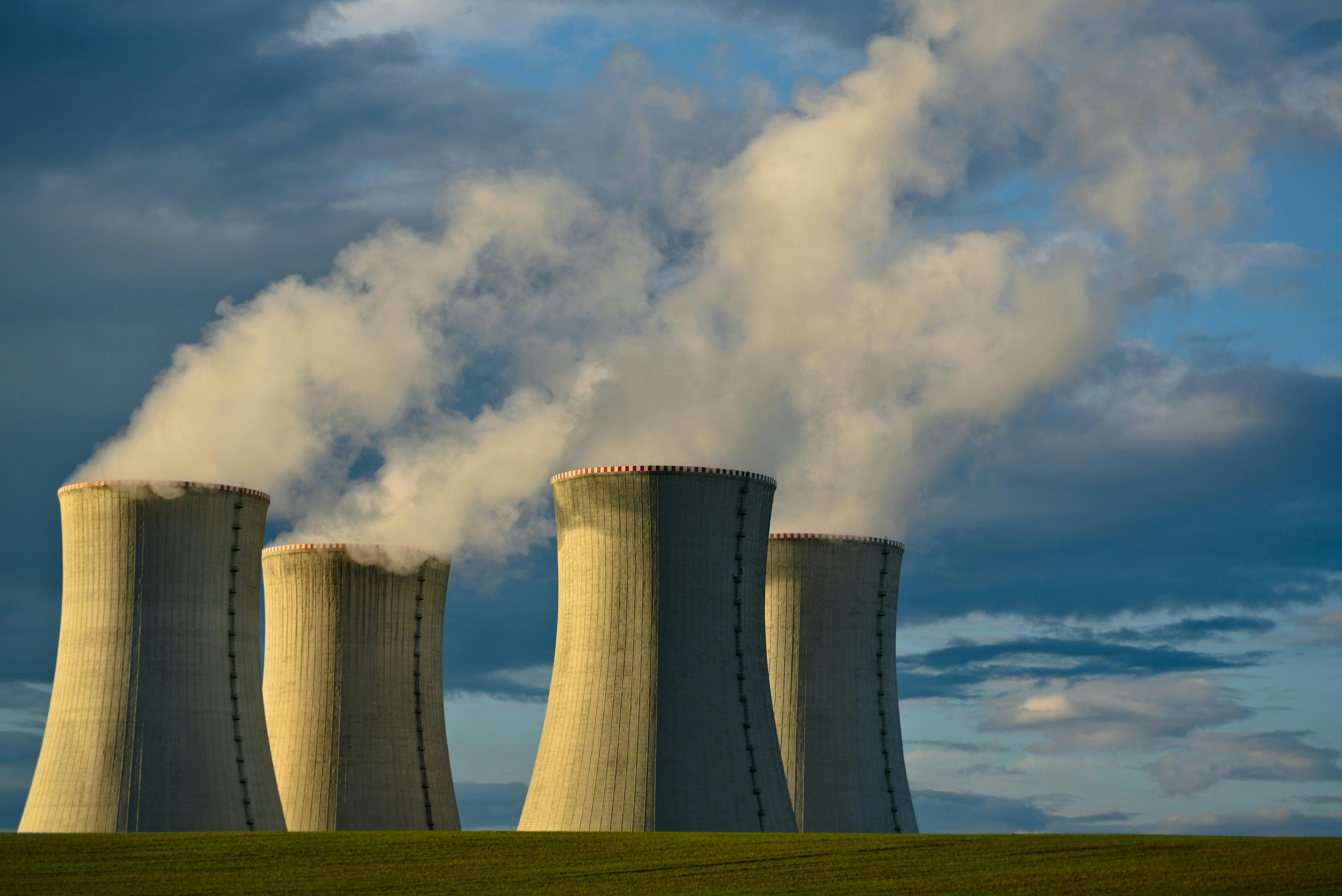 Four nuclear energy reactors on a blue sky background