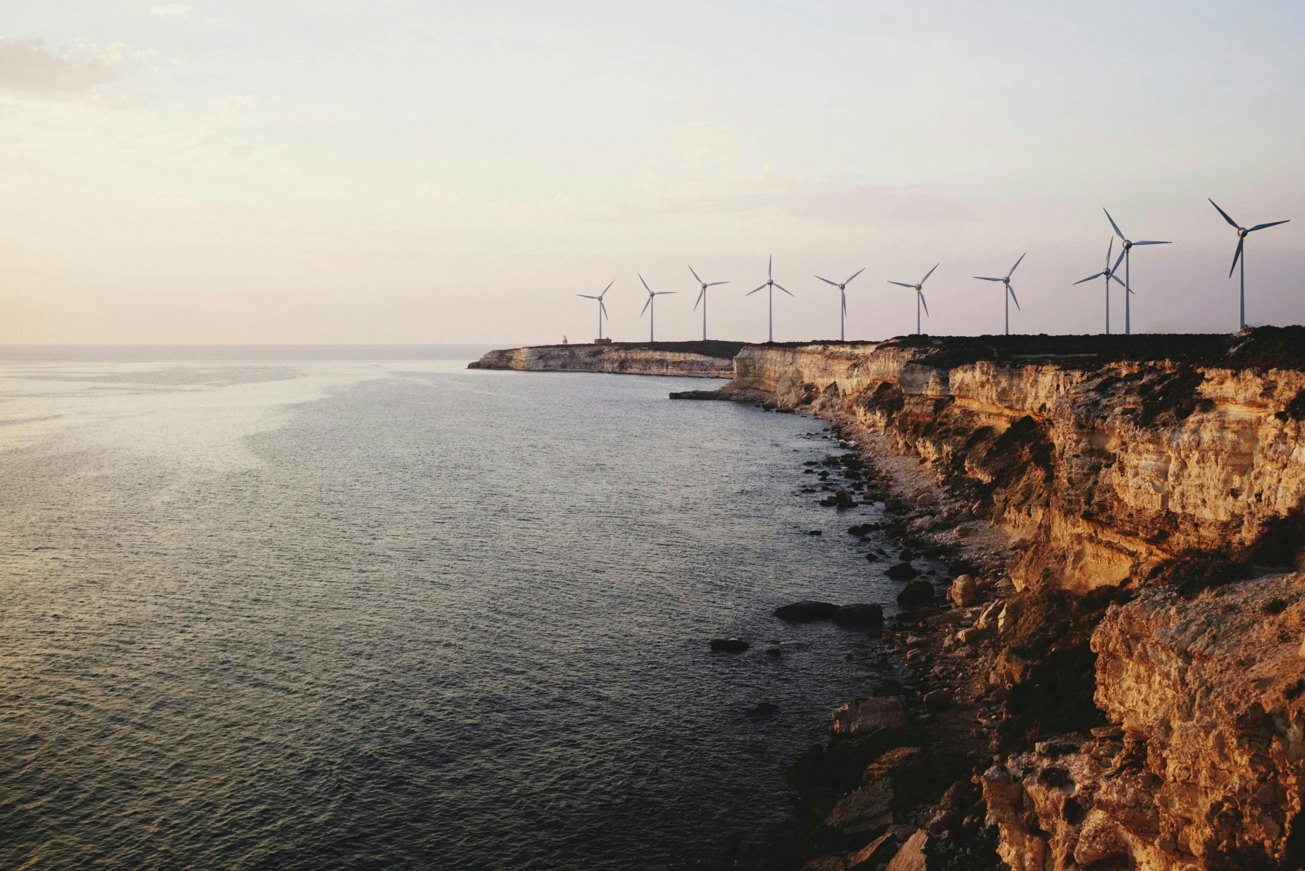 Wind turbines along a sea cliff