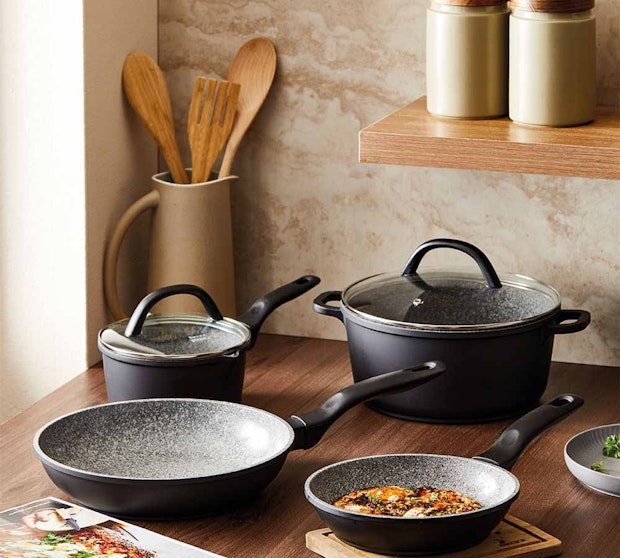 Baccarat STONEX2 4 piece Cookware set on a kitchen counter with utensils