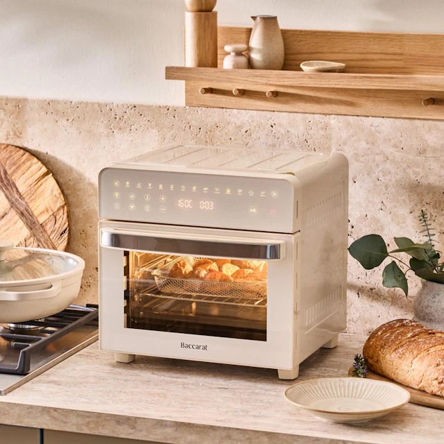 Baccarat NOOK Air Fryer oven in cream on a benchtop with an empty bowl