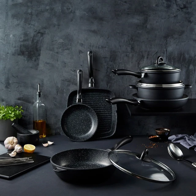 Baccarat STONE 6 Piece Cookware Set with Grill Pan on a counter, set against a dark background.
