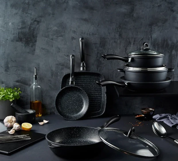 Baccarat STONE 6 Piece Cookware Set with Grill Pan on a counter, set against a dark background.