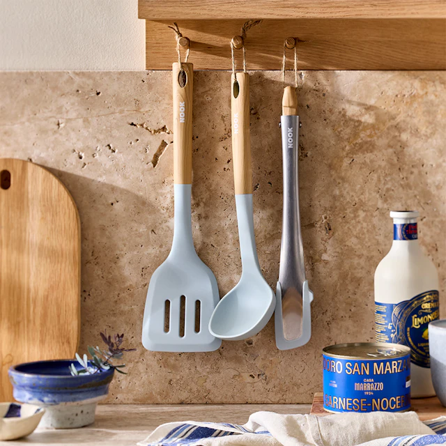 NOOK Sky cookware utensils hanging on a kitchen wall