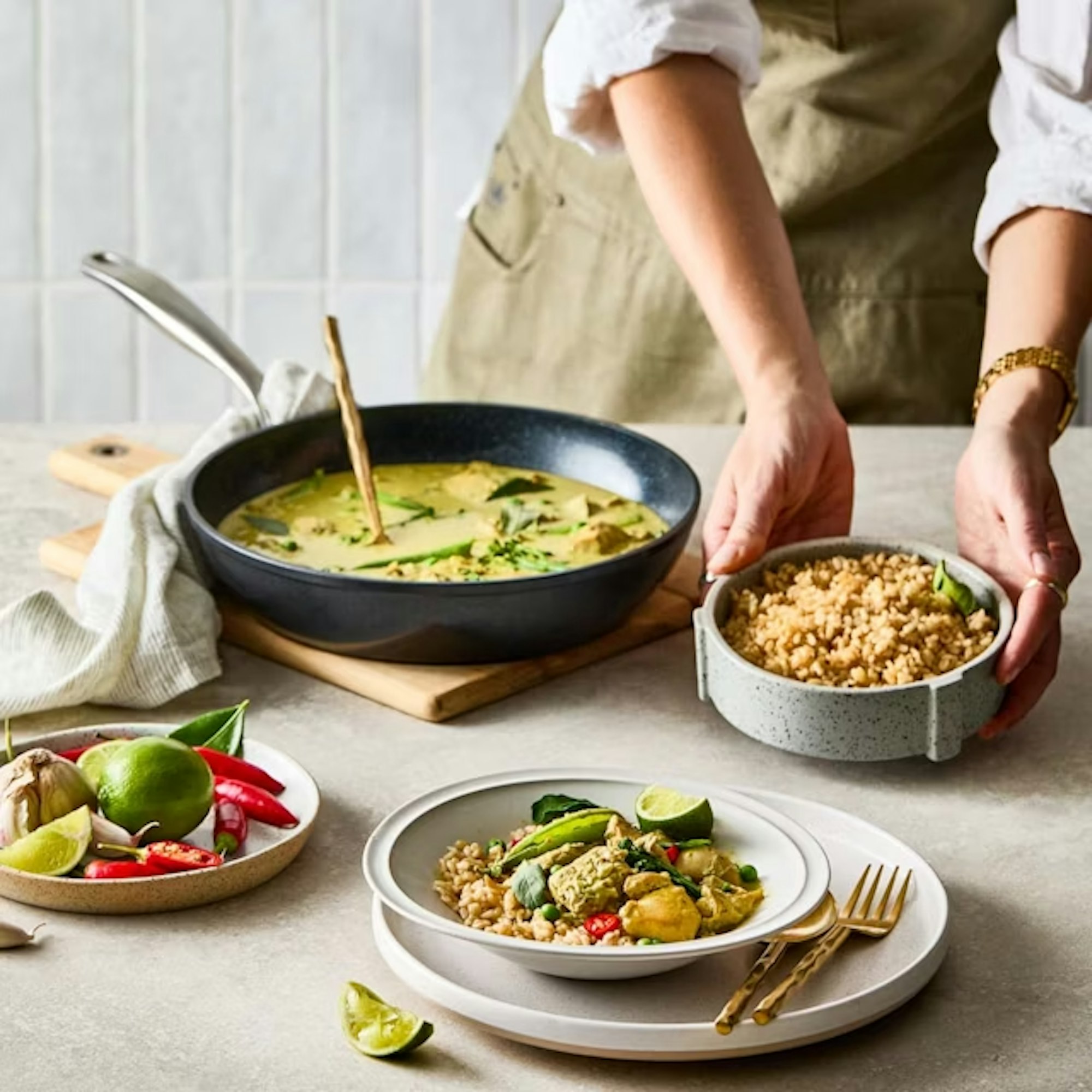 Person serving a Thai Green Curry Cooked in Baccarat Green Stone Cookware