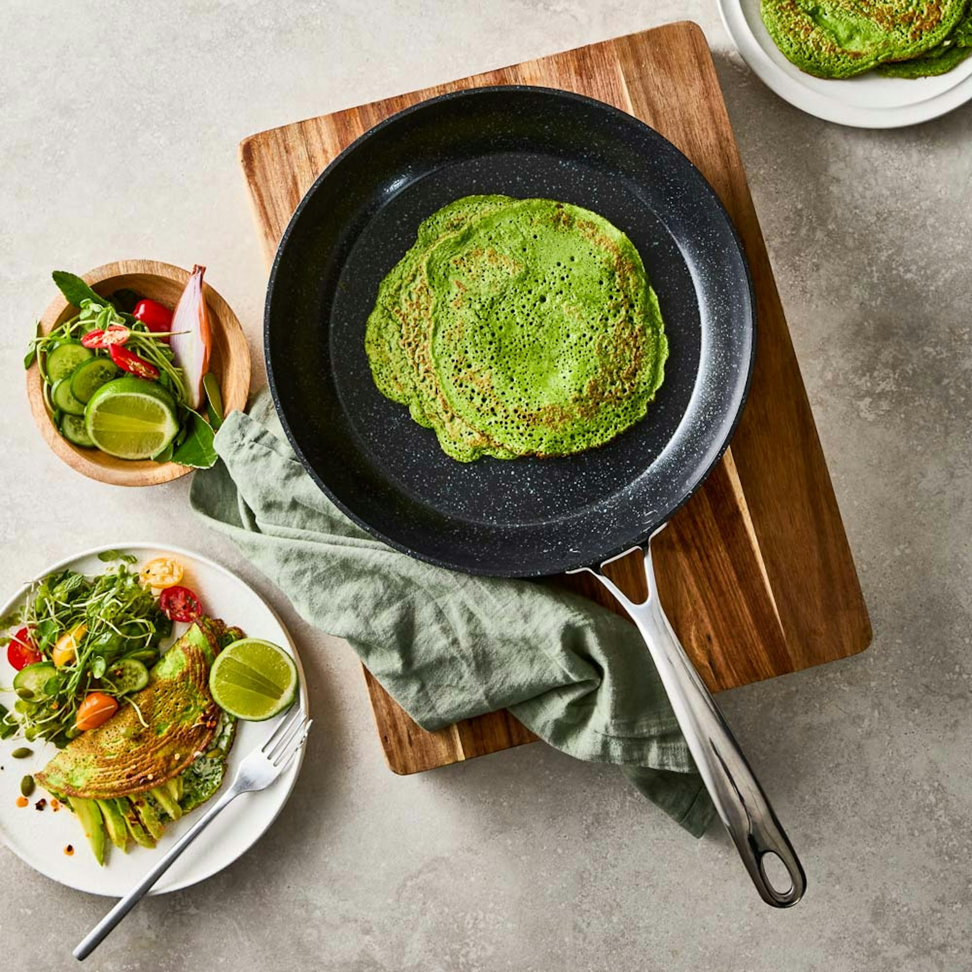 Overhead view of green pancake in a frypan. Super Greens Pancake recipe at Baccarat.