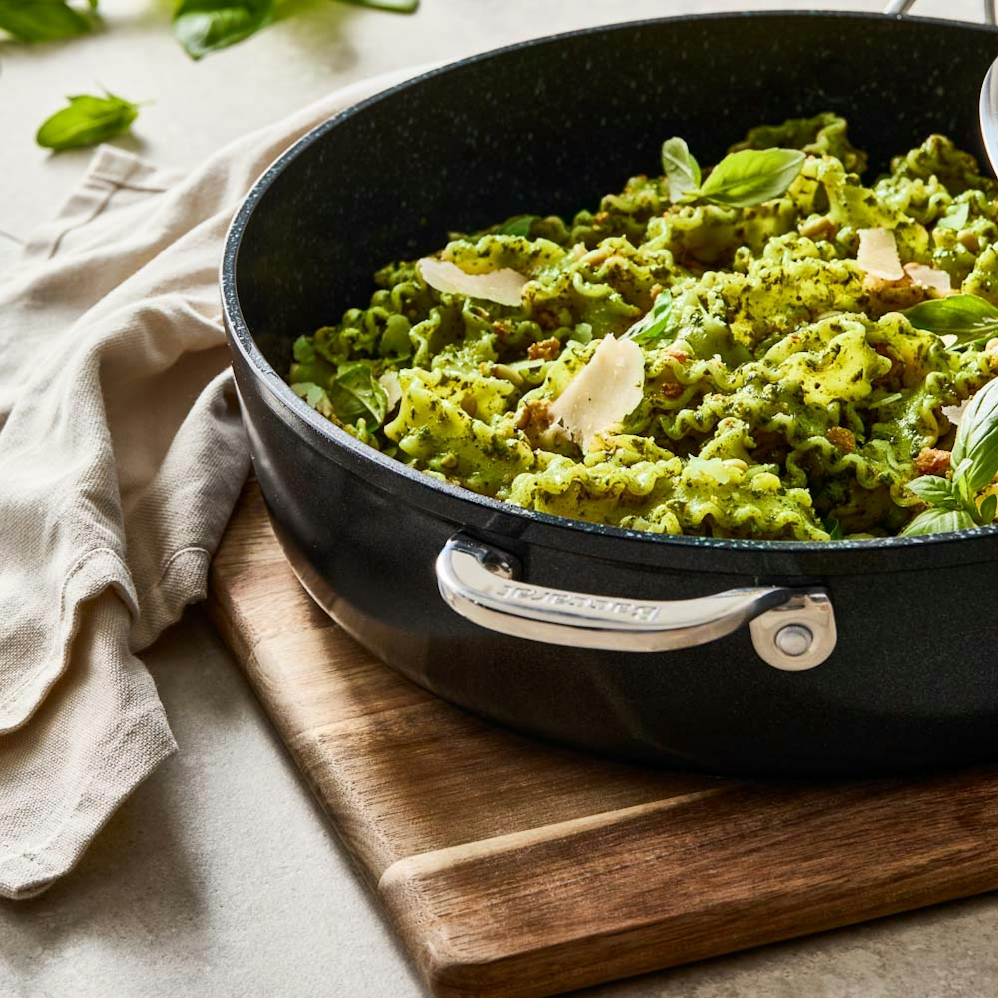 detail shot of pesto pasta in frypan with lid. Baccarat GREEN STONE Chef pan.