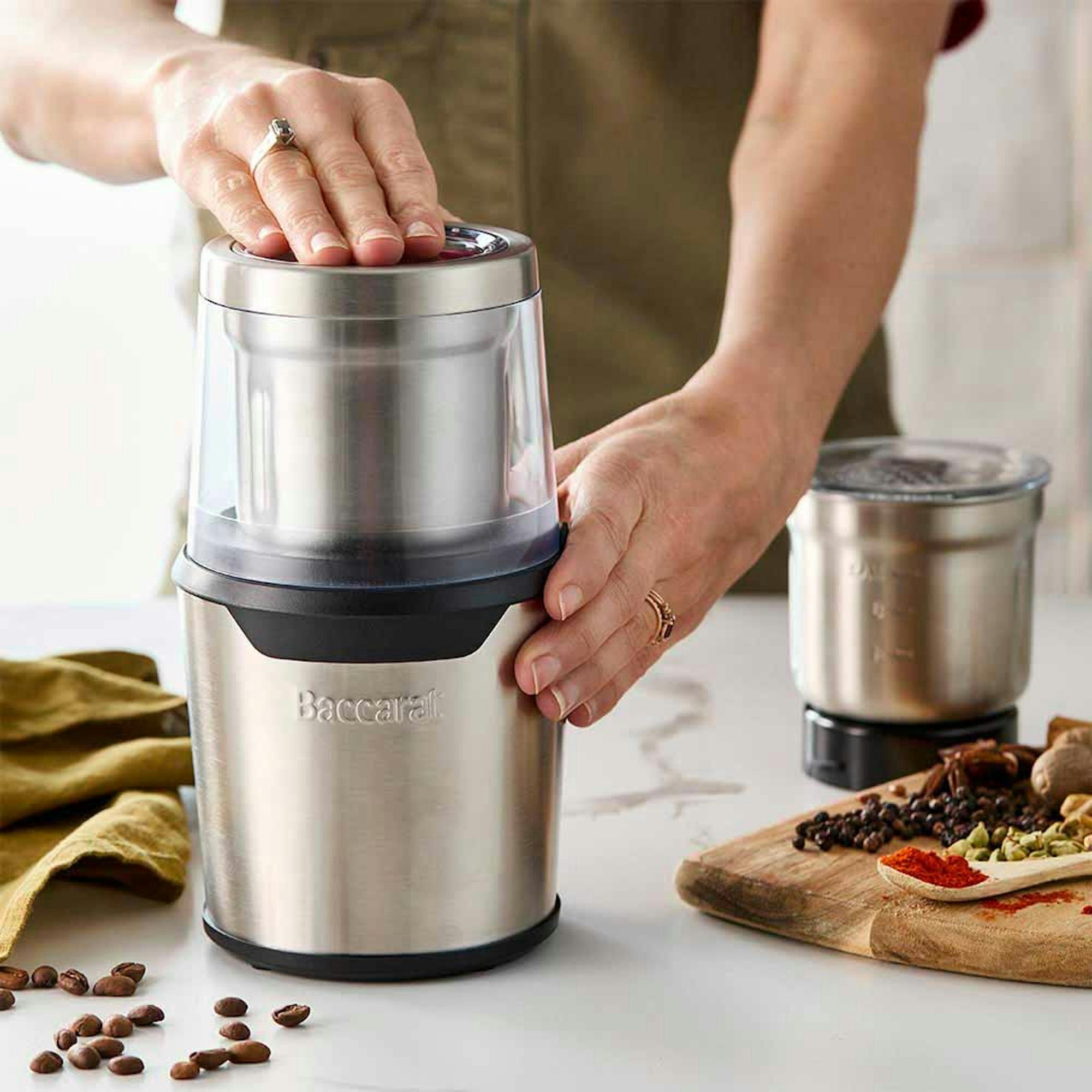 woman operating electric coffee grinder - Baccarat