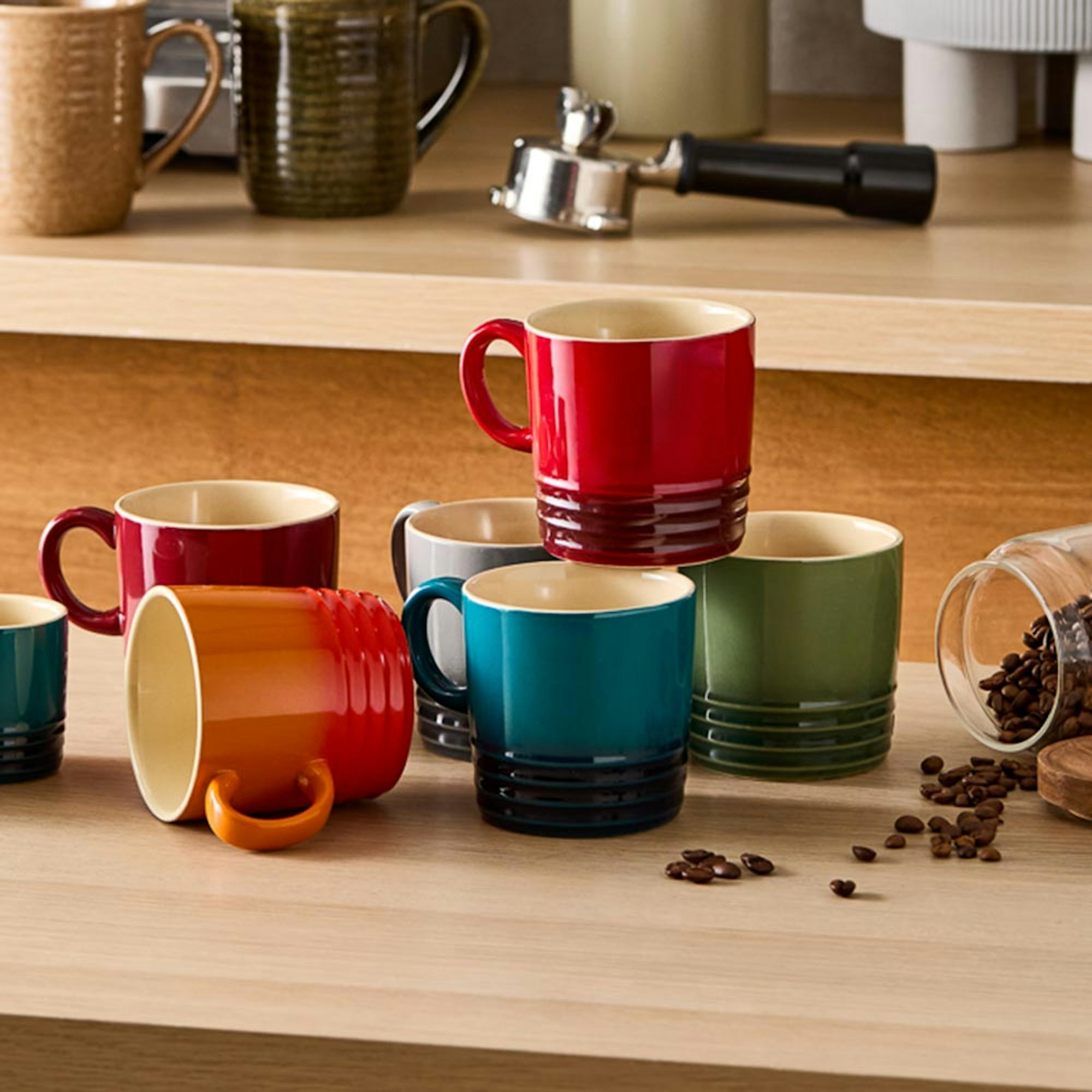 set of multi coloured mugs on wooden counter - Baccarat