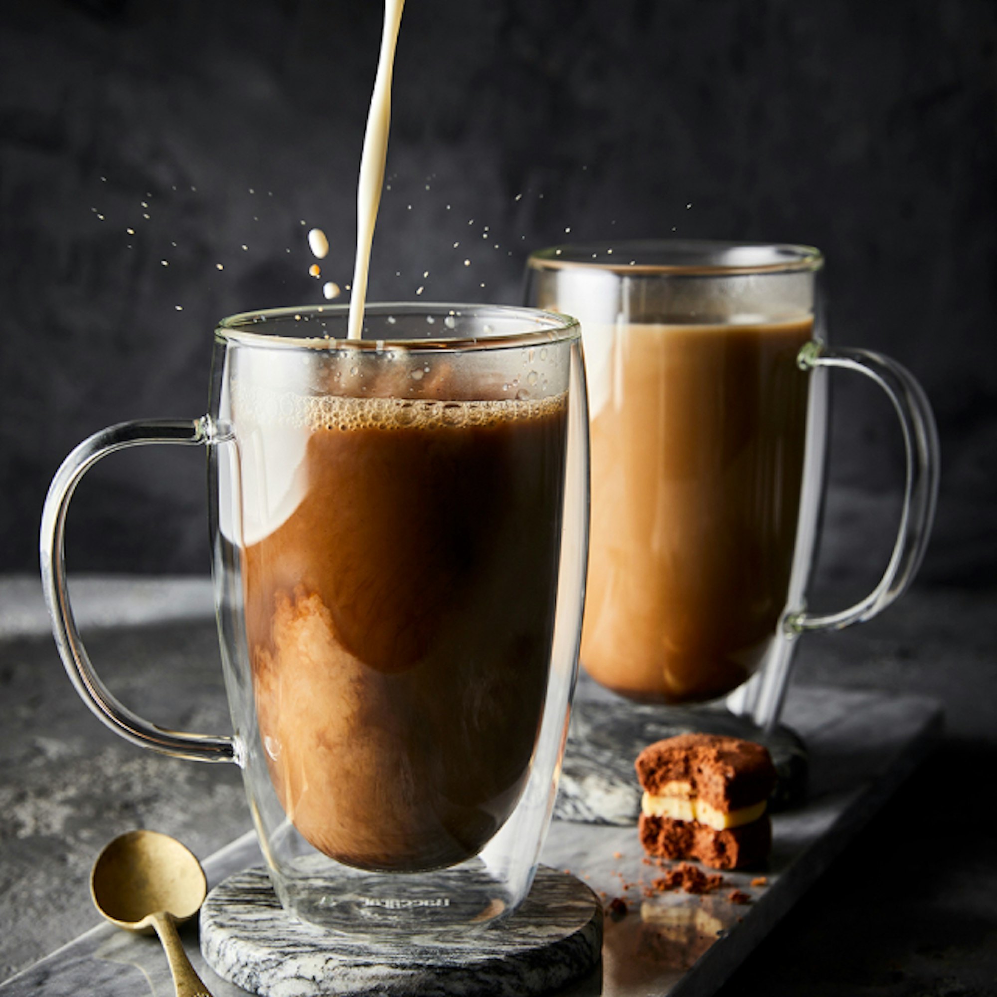 Coffee pouring into a Baccarat Barista double wall coffee cup with handle