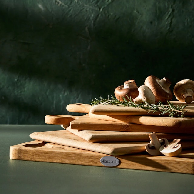 Stack of cutting boards on dark coloured bench