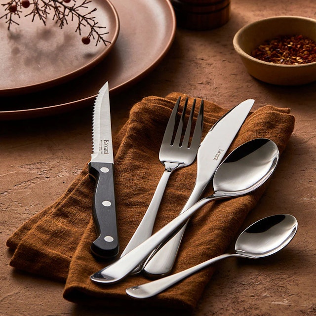 Baccarat cutlery set on a brown napkin