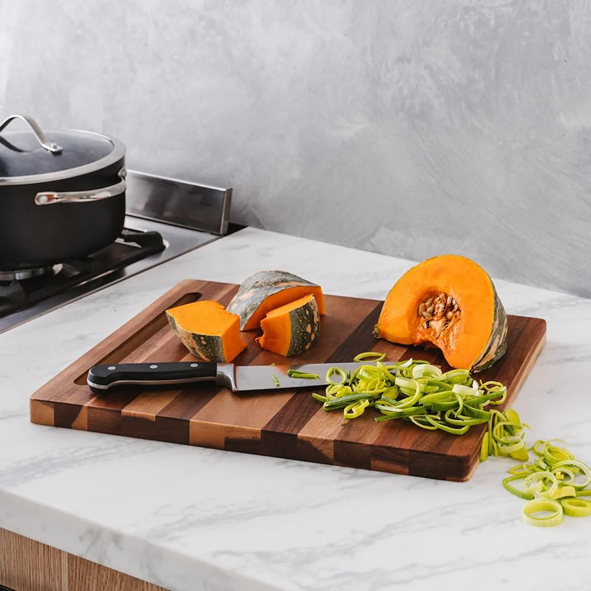 Butchers Corner chopping board with vegetables and a knife on it