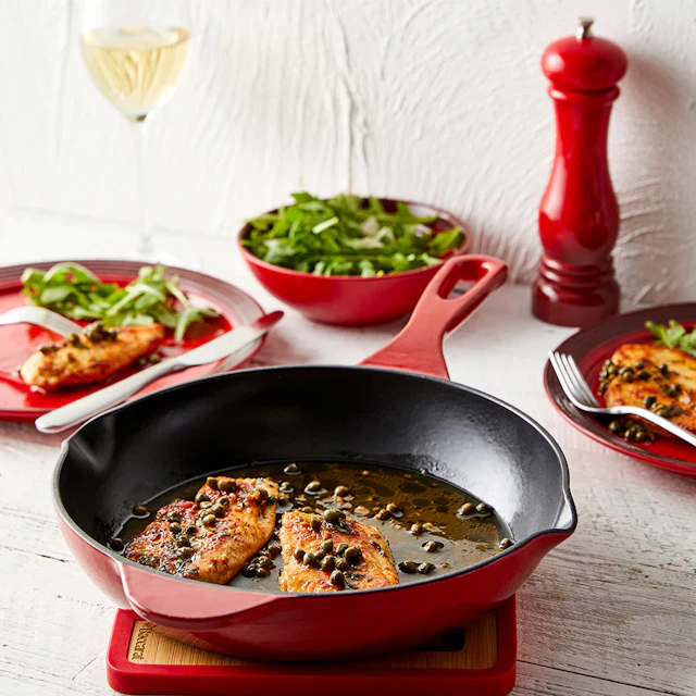 Red Baccarat Le Connoisseur frypan with food in it