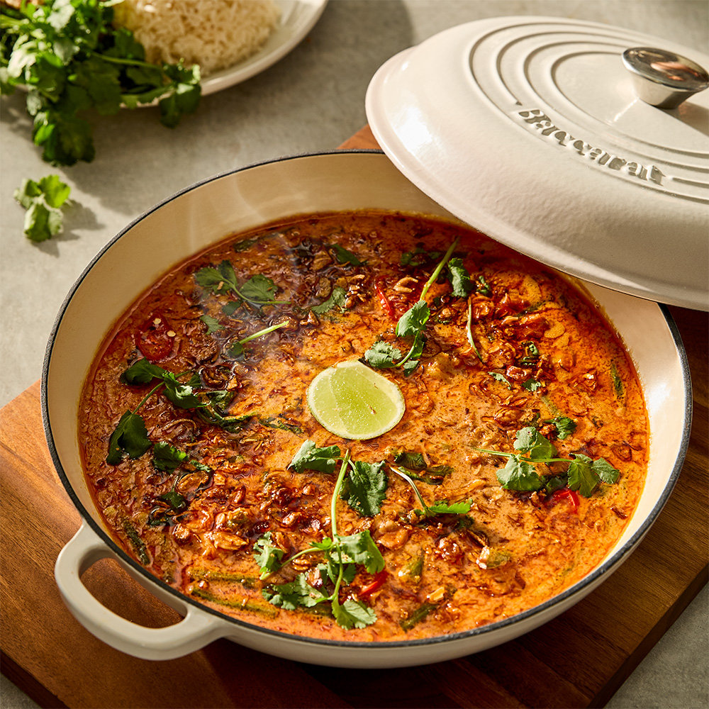 Baccarat Le Connoisseur cookware with food in it on and the lid leaning against it
