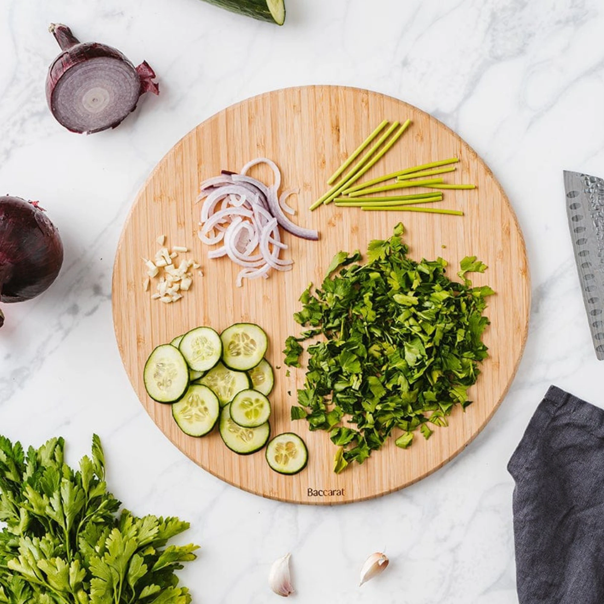 Baccarat cutting board with cut vegetables on it