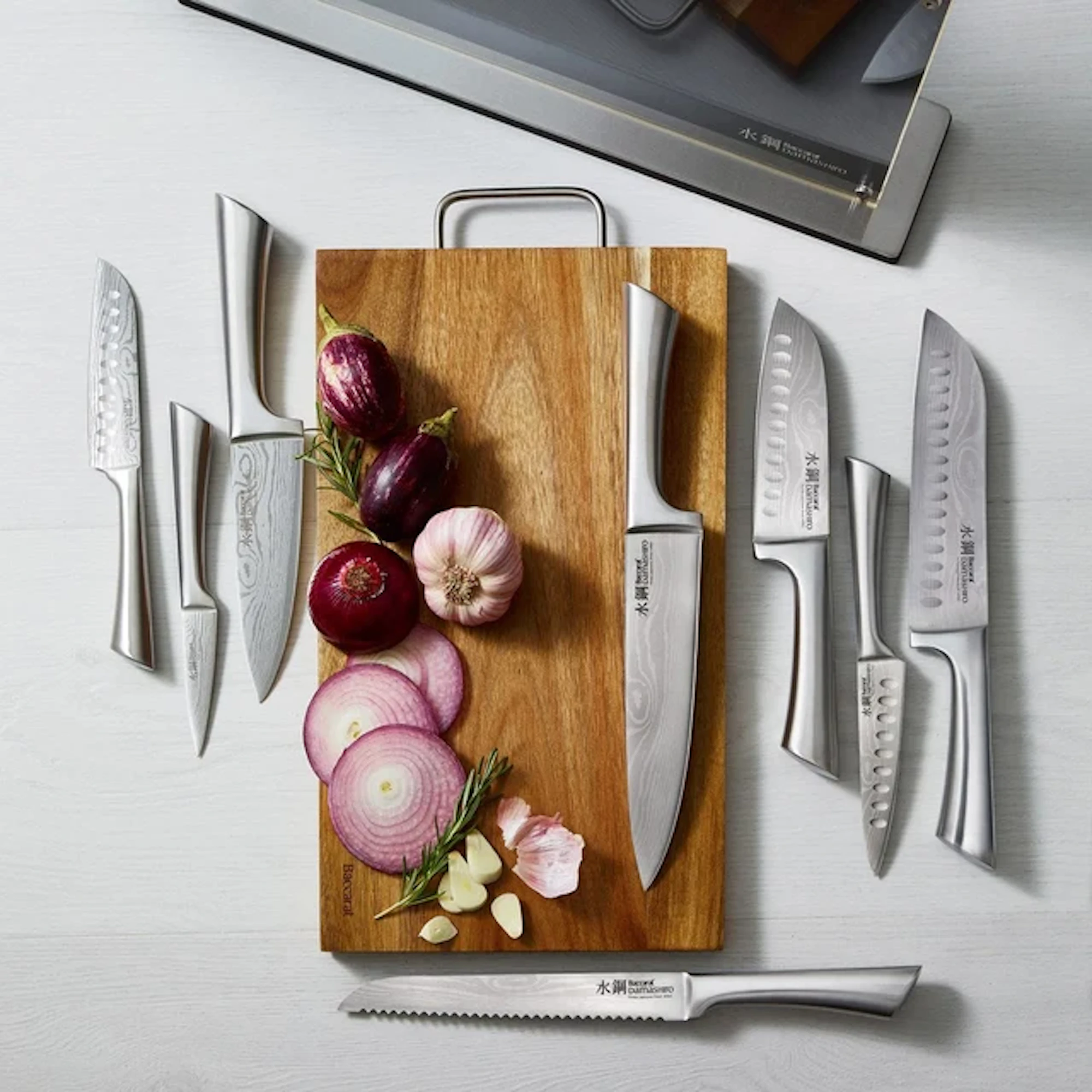 Baccarat Damashiro Bodo 10 Piece Japanese Steel Knife Block with Chopping Board, flat lay on a grey surface