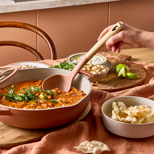 NOOK Terracotta sauté pan with a serving spoon on a table