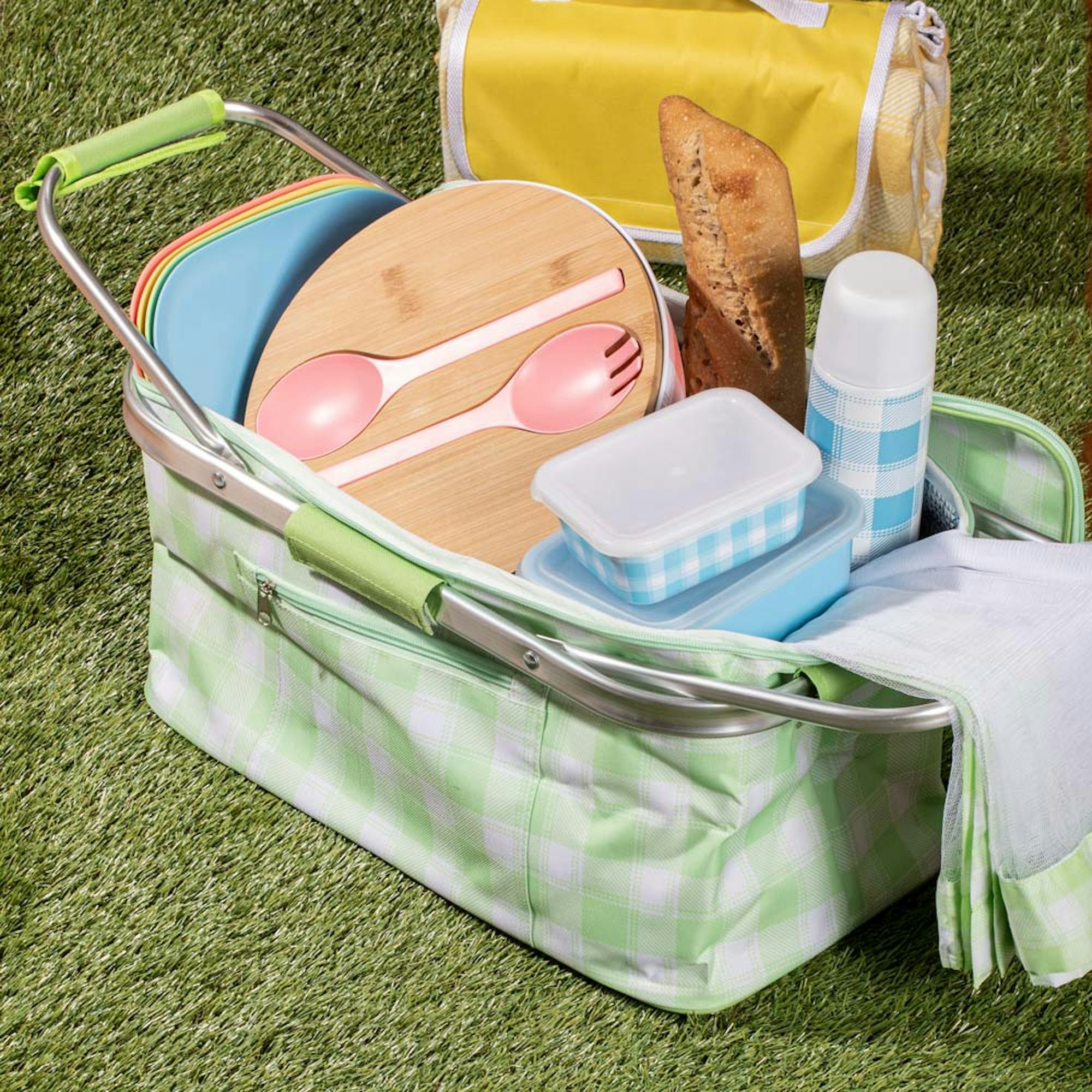 Green and white gingham picnic basket with picnicware