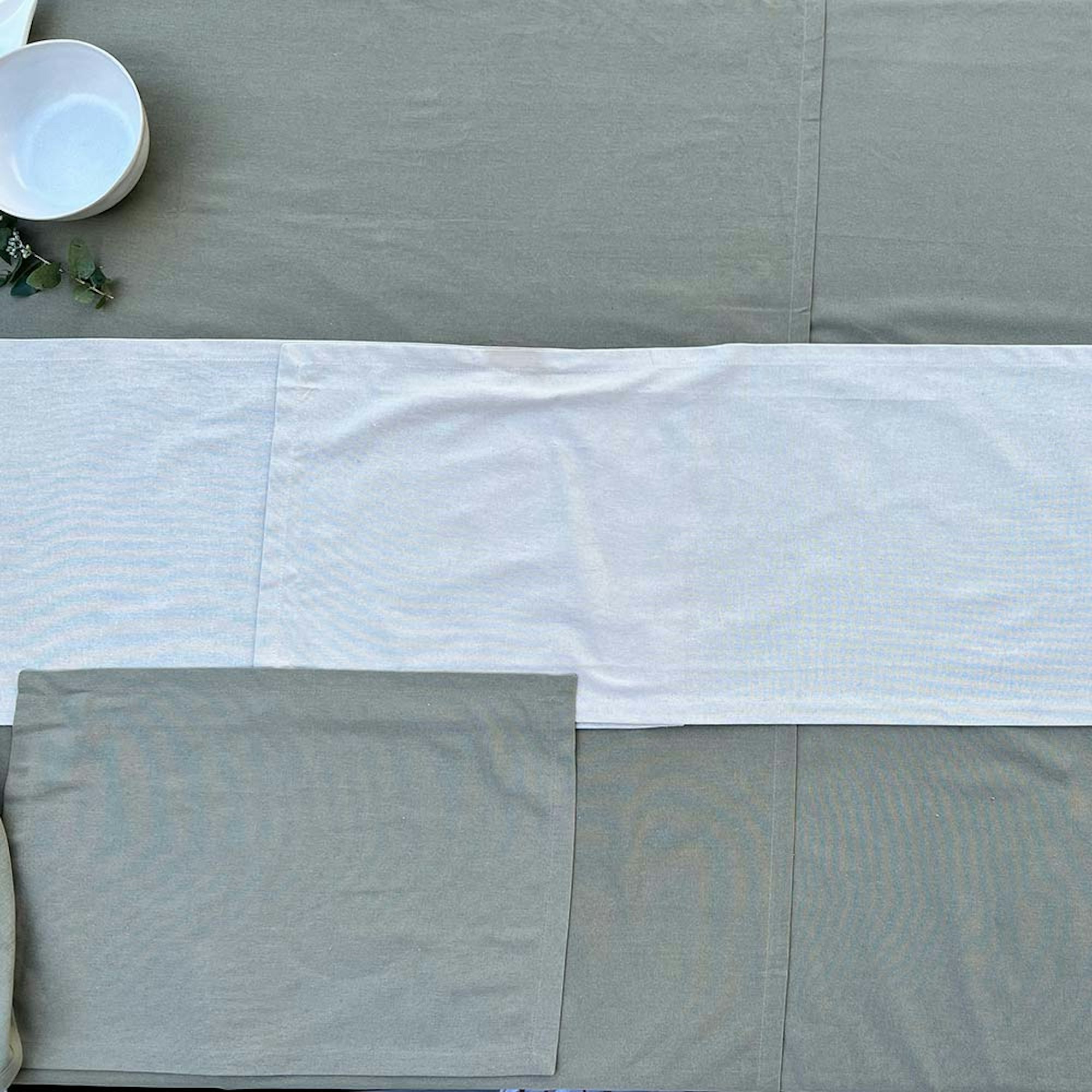 How to style a dining table for a dinner party. Step 3 select a placemat. Empty table with table cloth, runner and placemat.