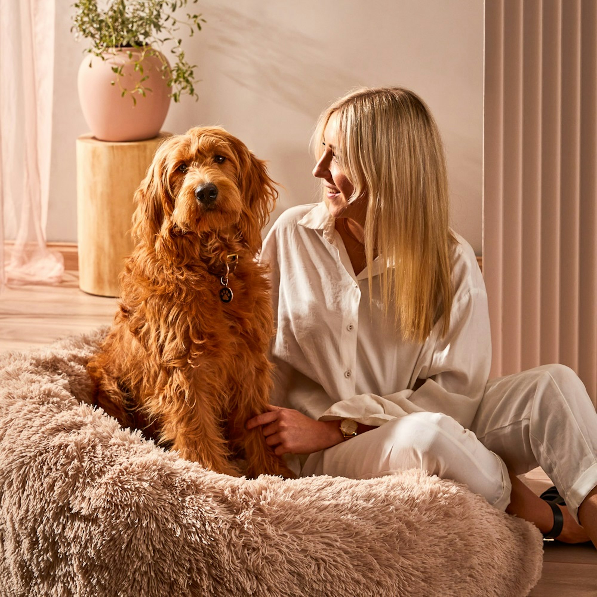 woman sitting with brown dog