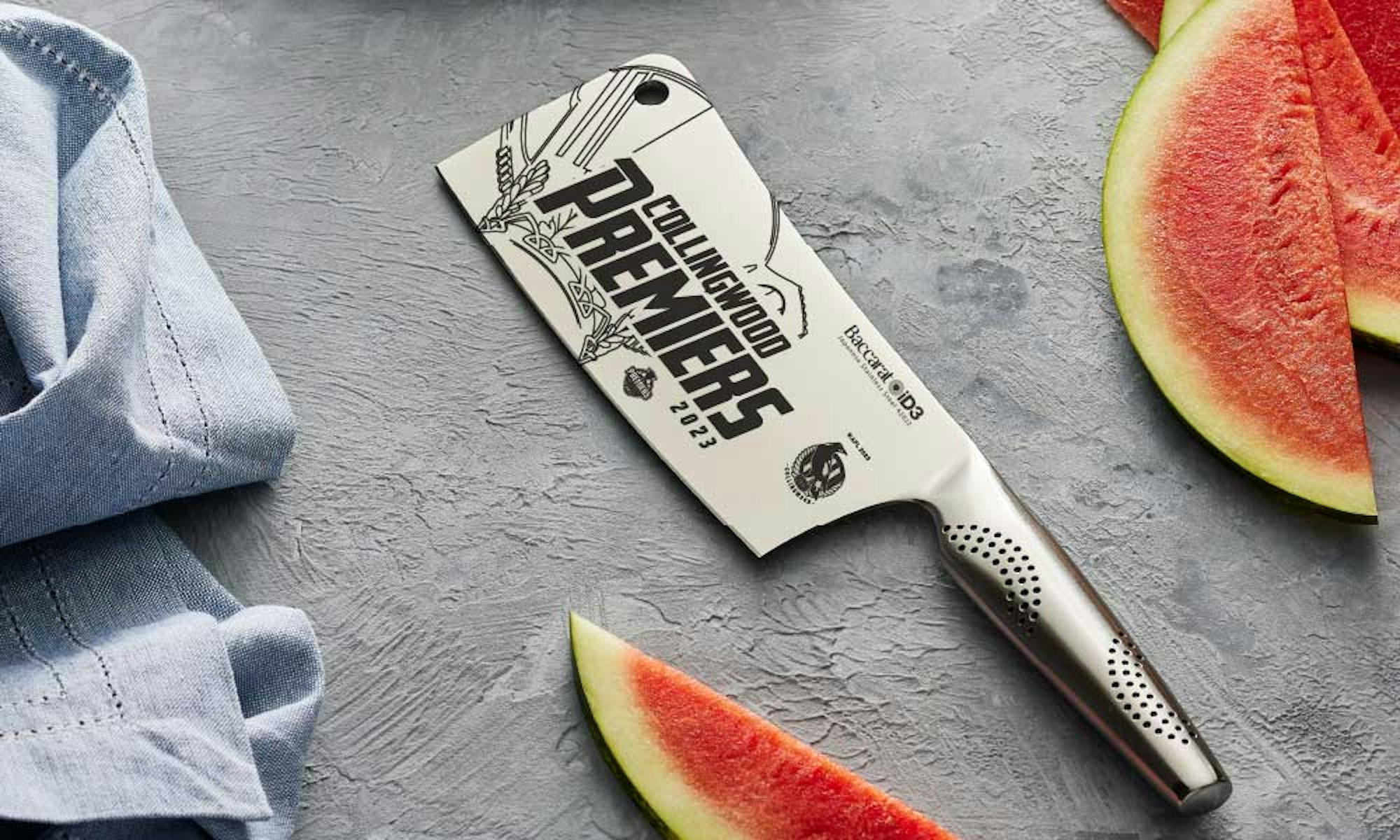 Christmas Gift Guide 2023. Personalised Gifts. Custom Chef. Cleaver with laser etch football design surrounded by watermelon.