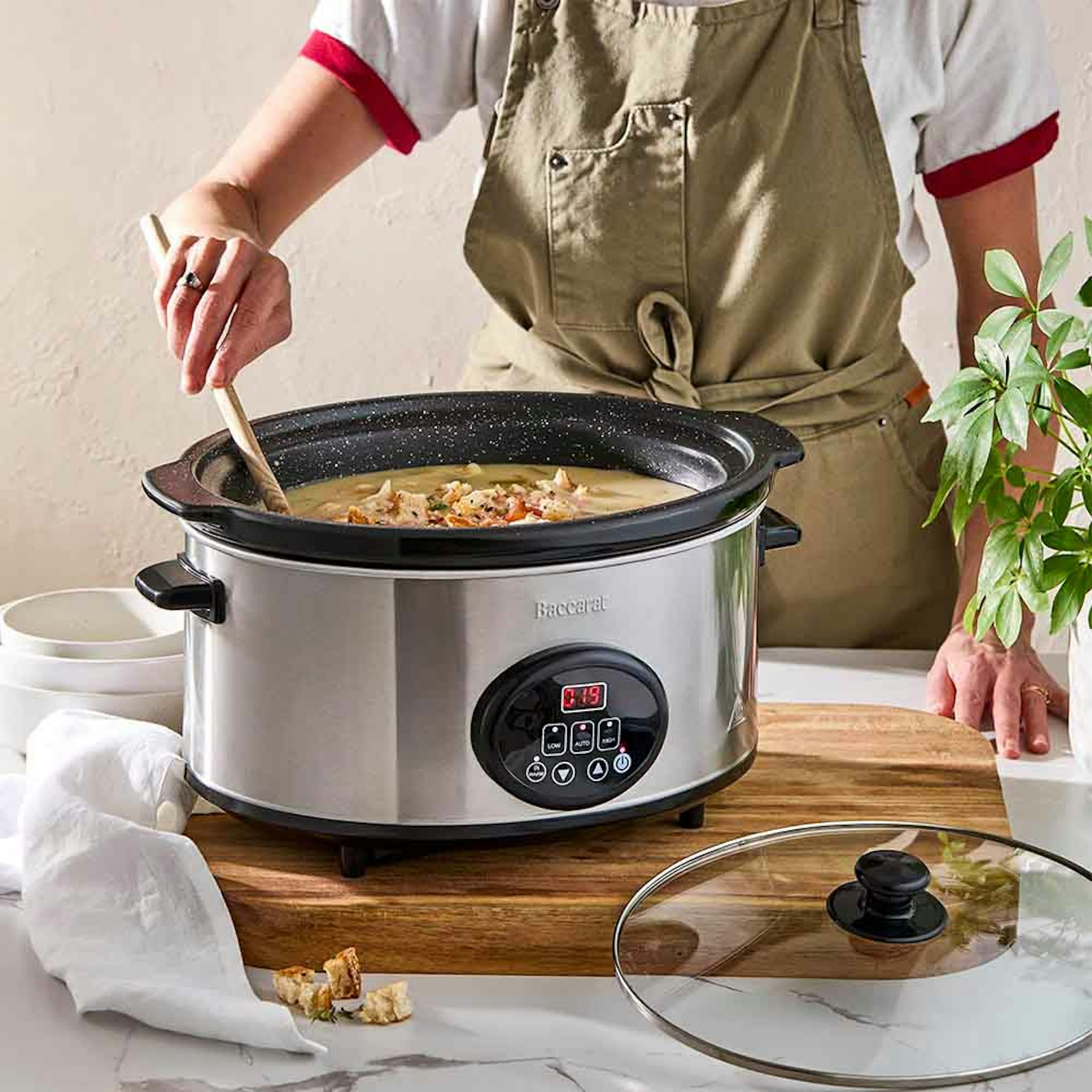 Woman stirring stew in a slow cooker. Which is the best slow cooker blog at House.