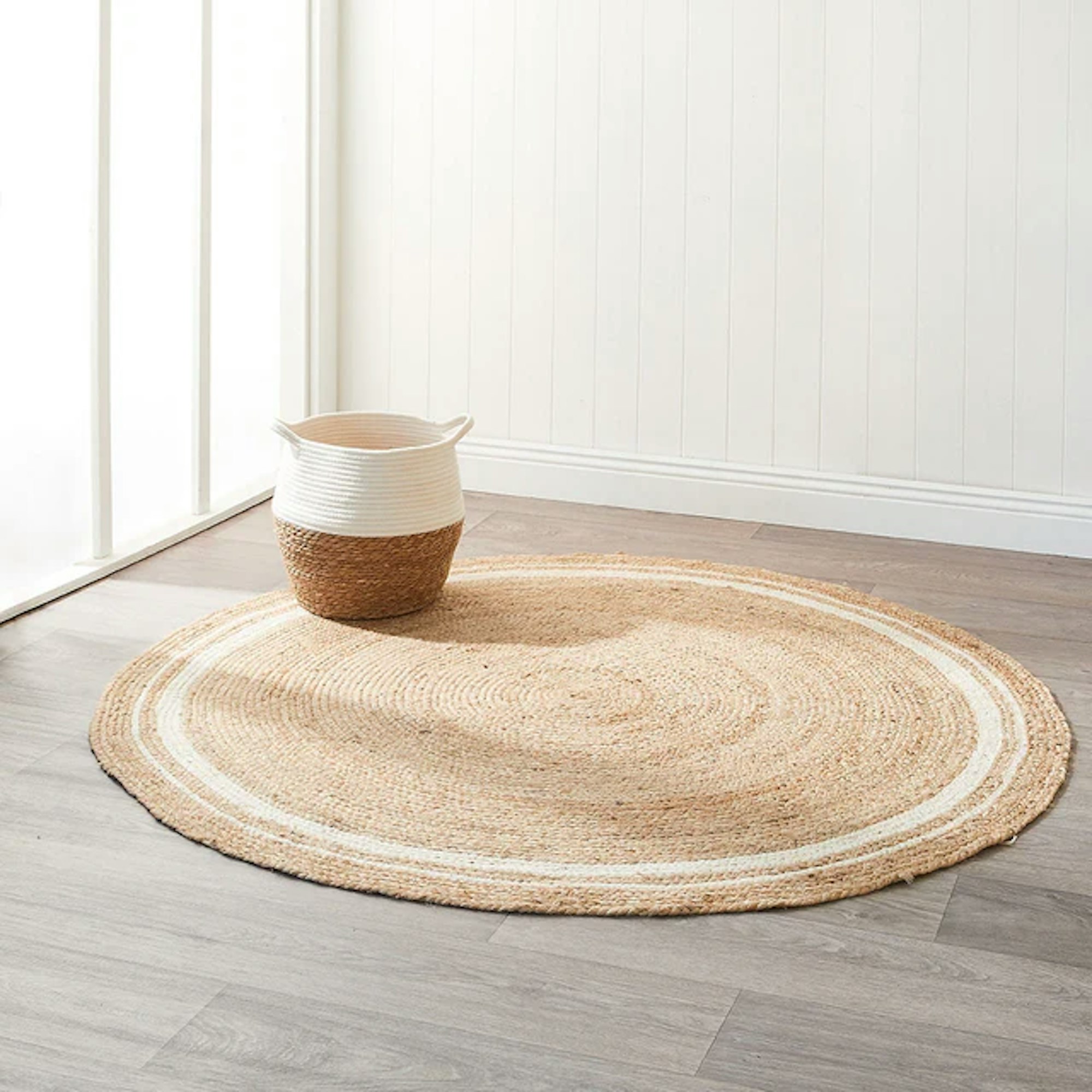 Round rug with wooden basket sitting on top