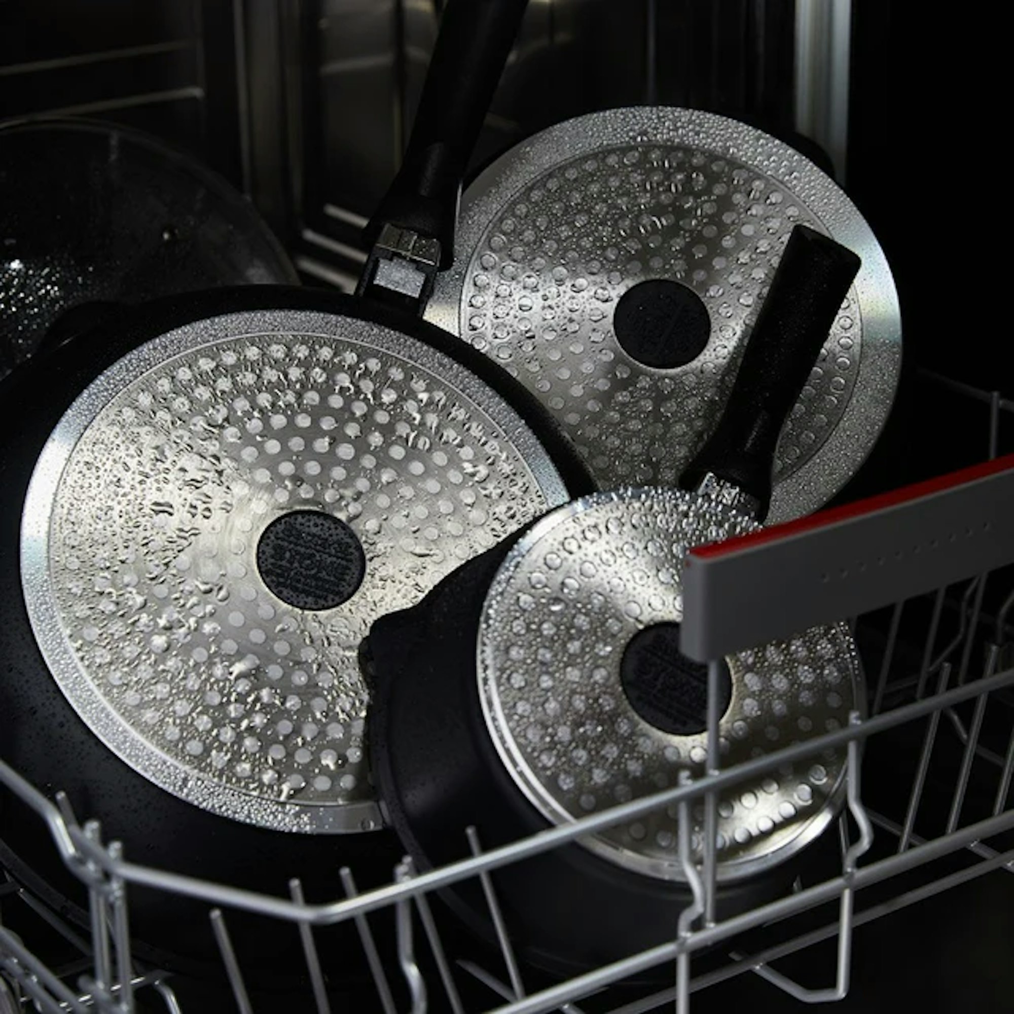 non-stick pans in a dishwasher with water