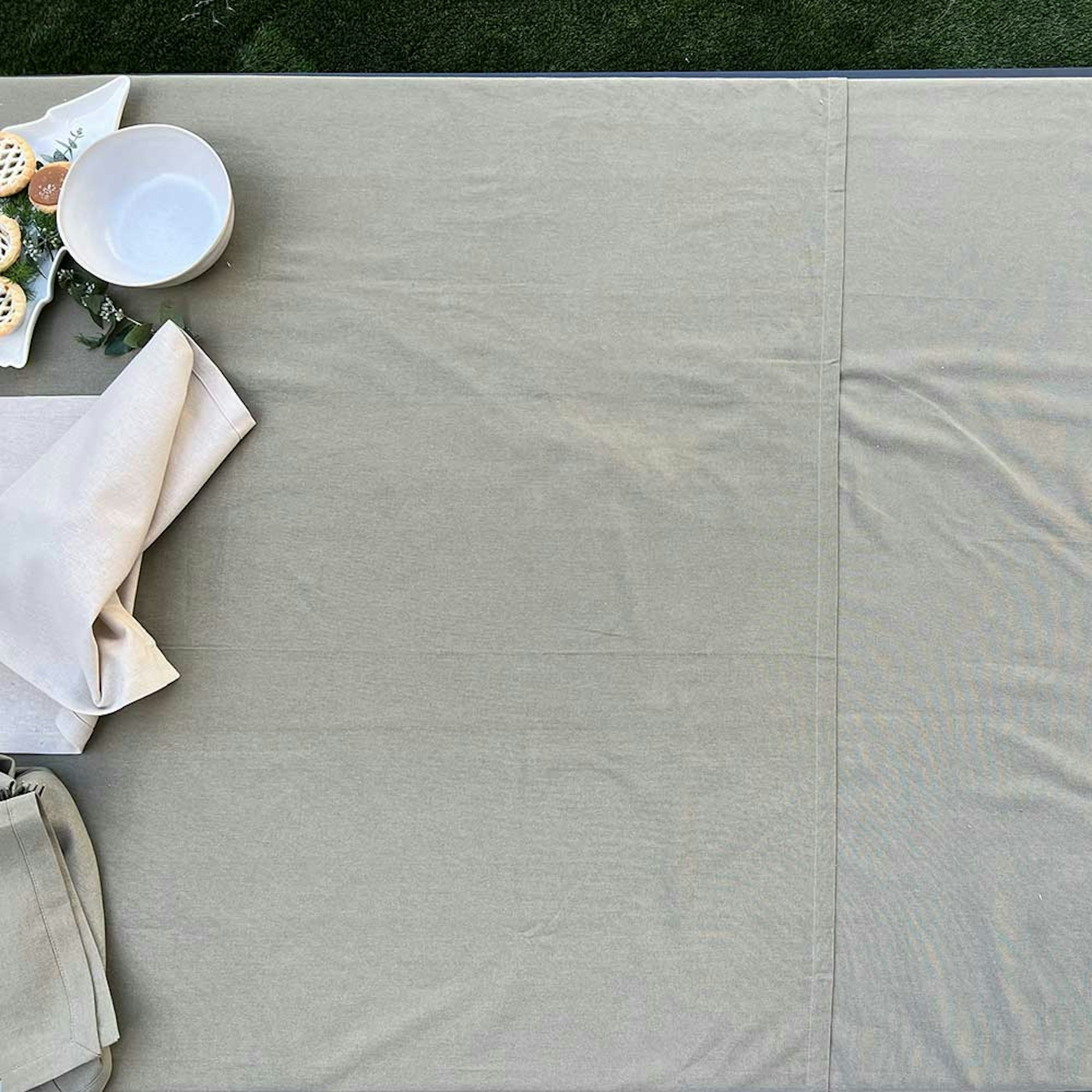 How to style a dining table for a dinner party. Step 1 preparing the table. Empty table with green table cloth.