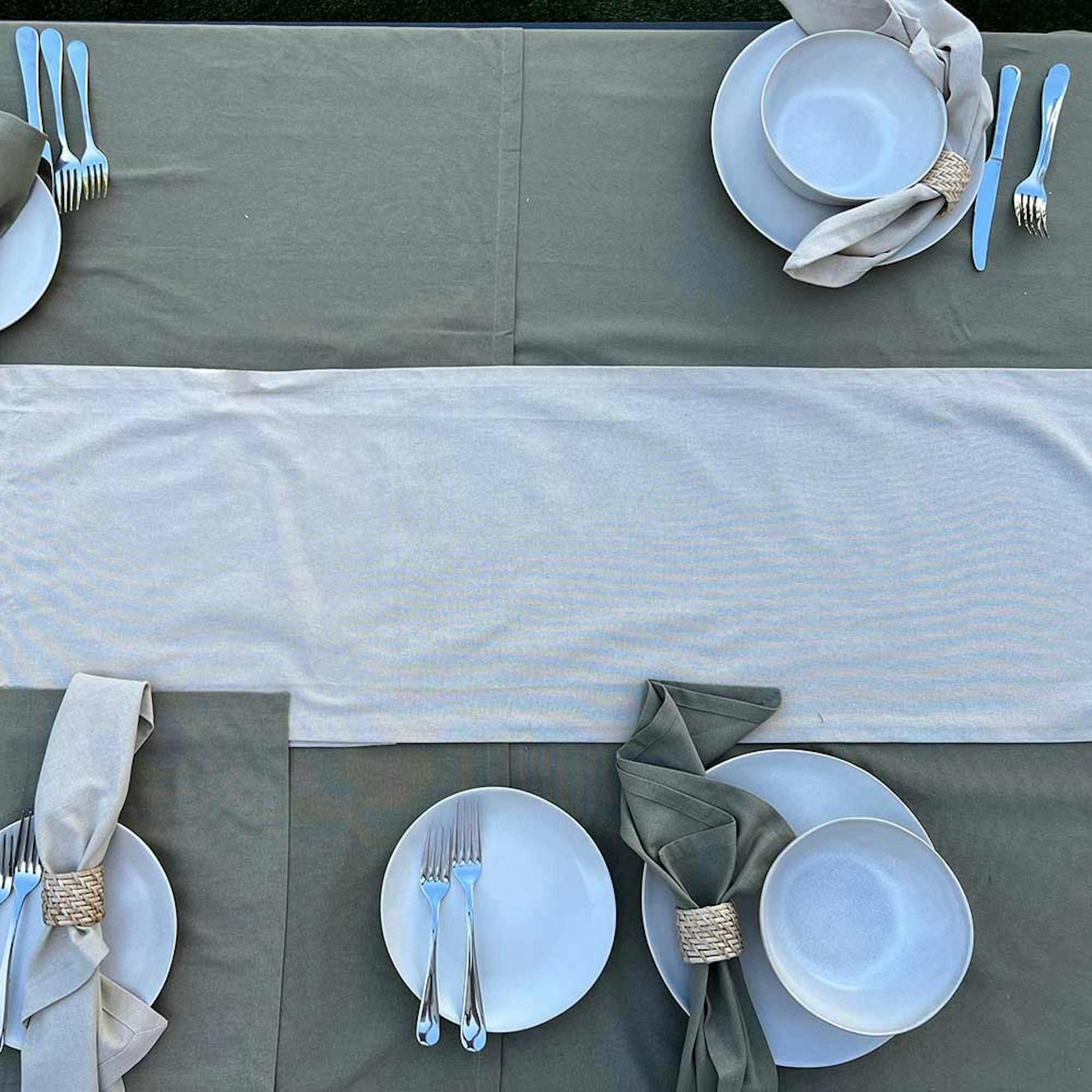 How to style a dining table for a dinner party. Step 5 place your napkins. Overhead of table linen, dinner set, and cutlery.