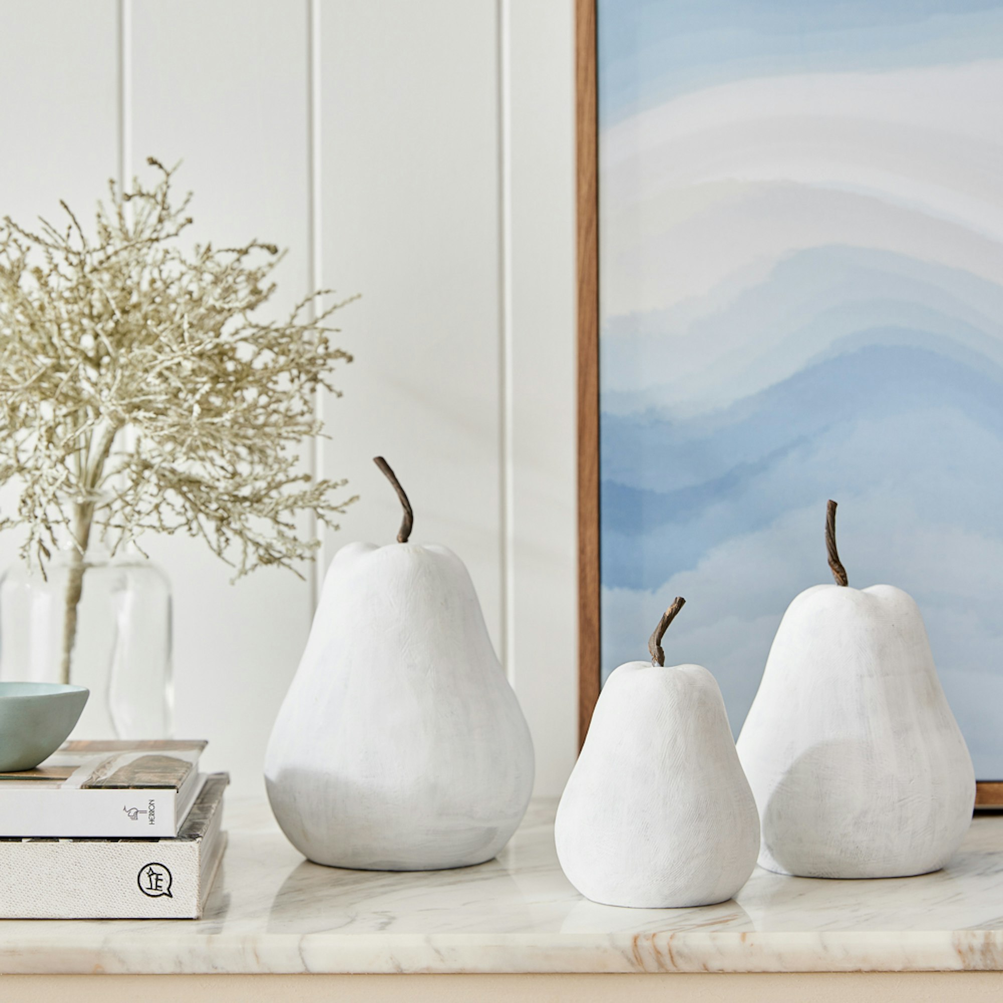 set of 3 cement pears on hallway table. Home with Deborah Hutton SS23 collection.
