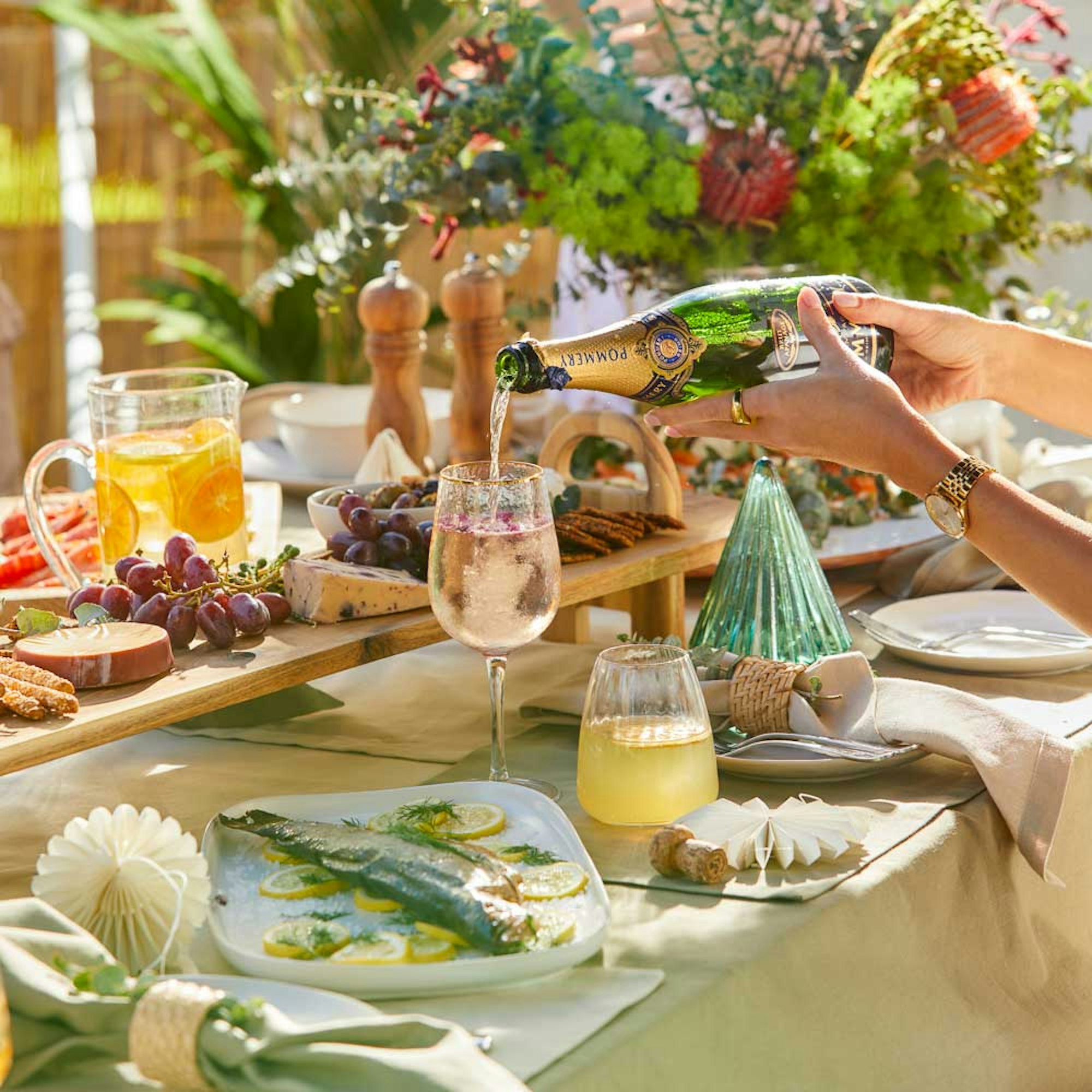 How to Style a Table setting in 8 Steps - House blog. Outdoor Christmas party with table linen, platters, wine glasses, and decorations.