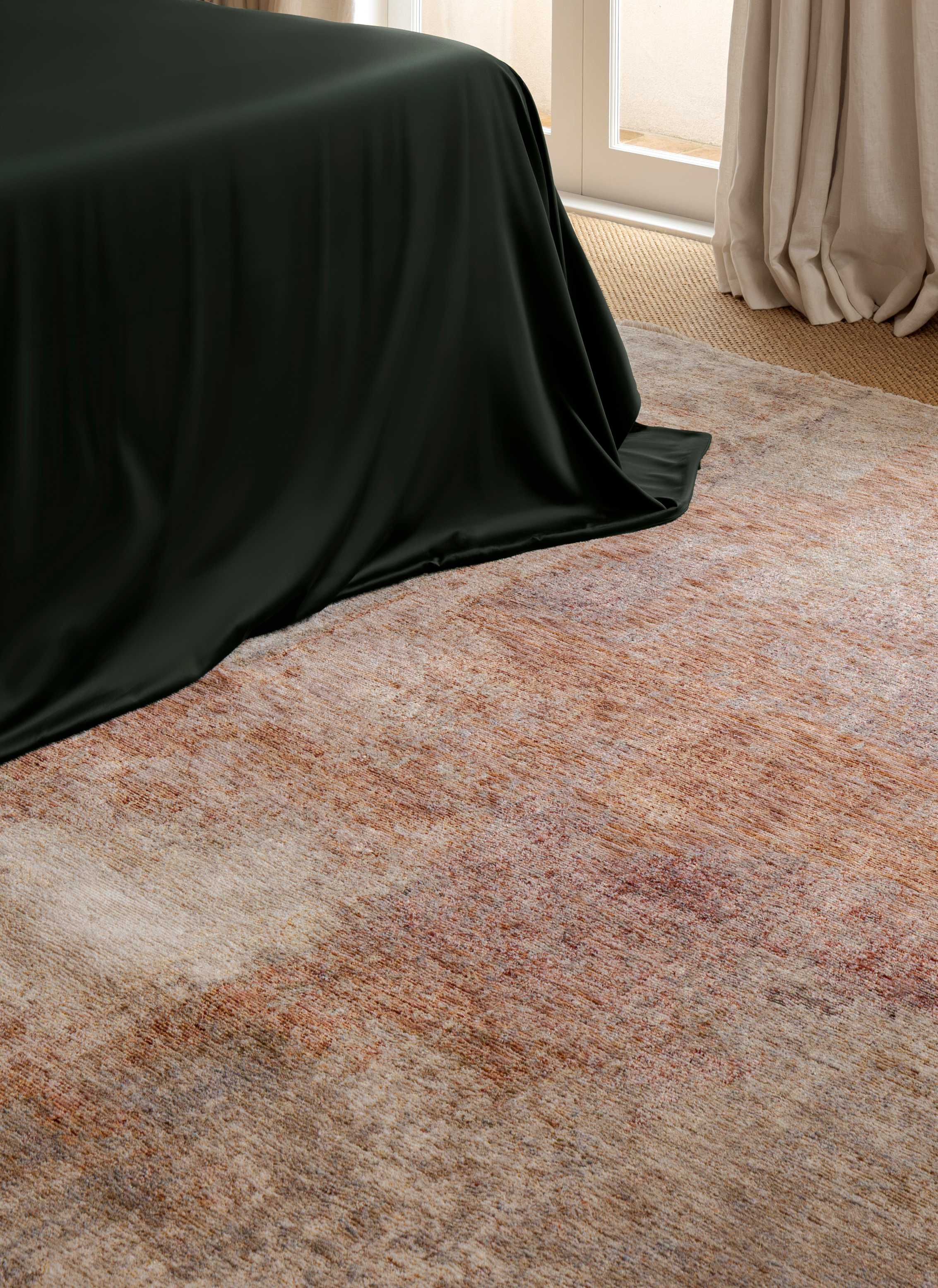 Close-up of Darren Palmer Sierra Dusk rug showcasing the distressed dusk-toned texture in soft rust, beige, and taupe hues beside dark green bedding and floor-length curtains
