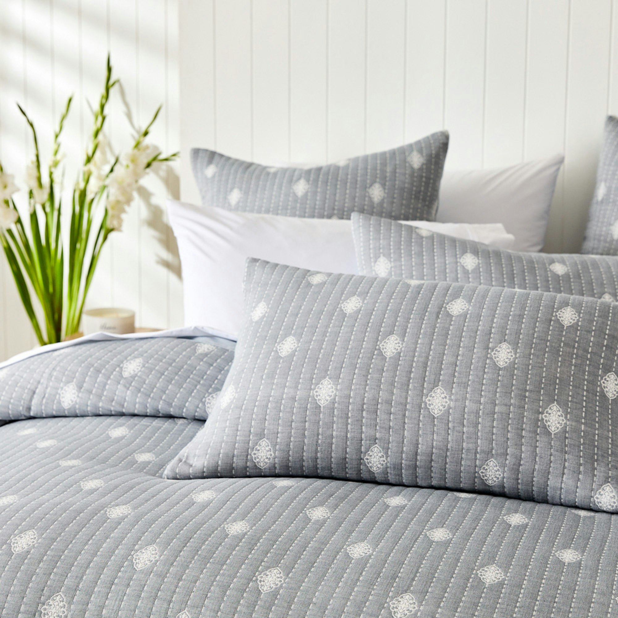 Home with Deborah Hutton SS23 coastal bedroom setting with grey quilt cover with white diamonds