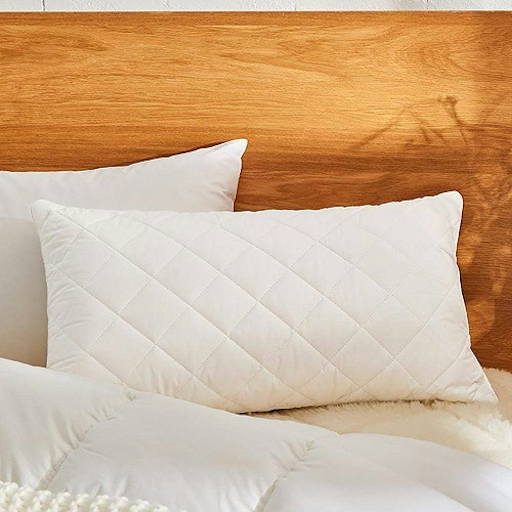 Pillow stack with wooden headboard