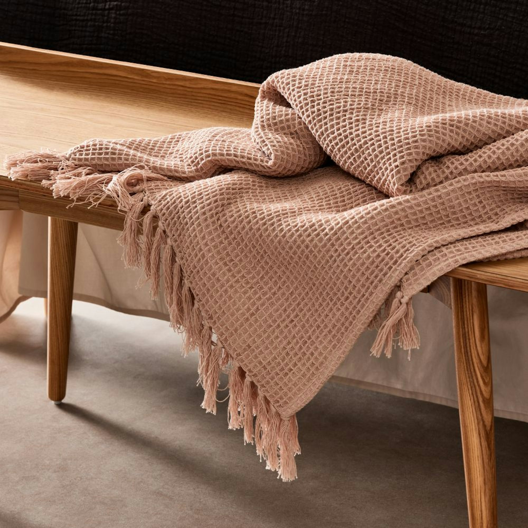 Home Beautiful Collection waffle throw draped over wooden bench