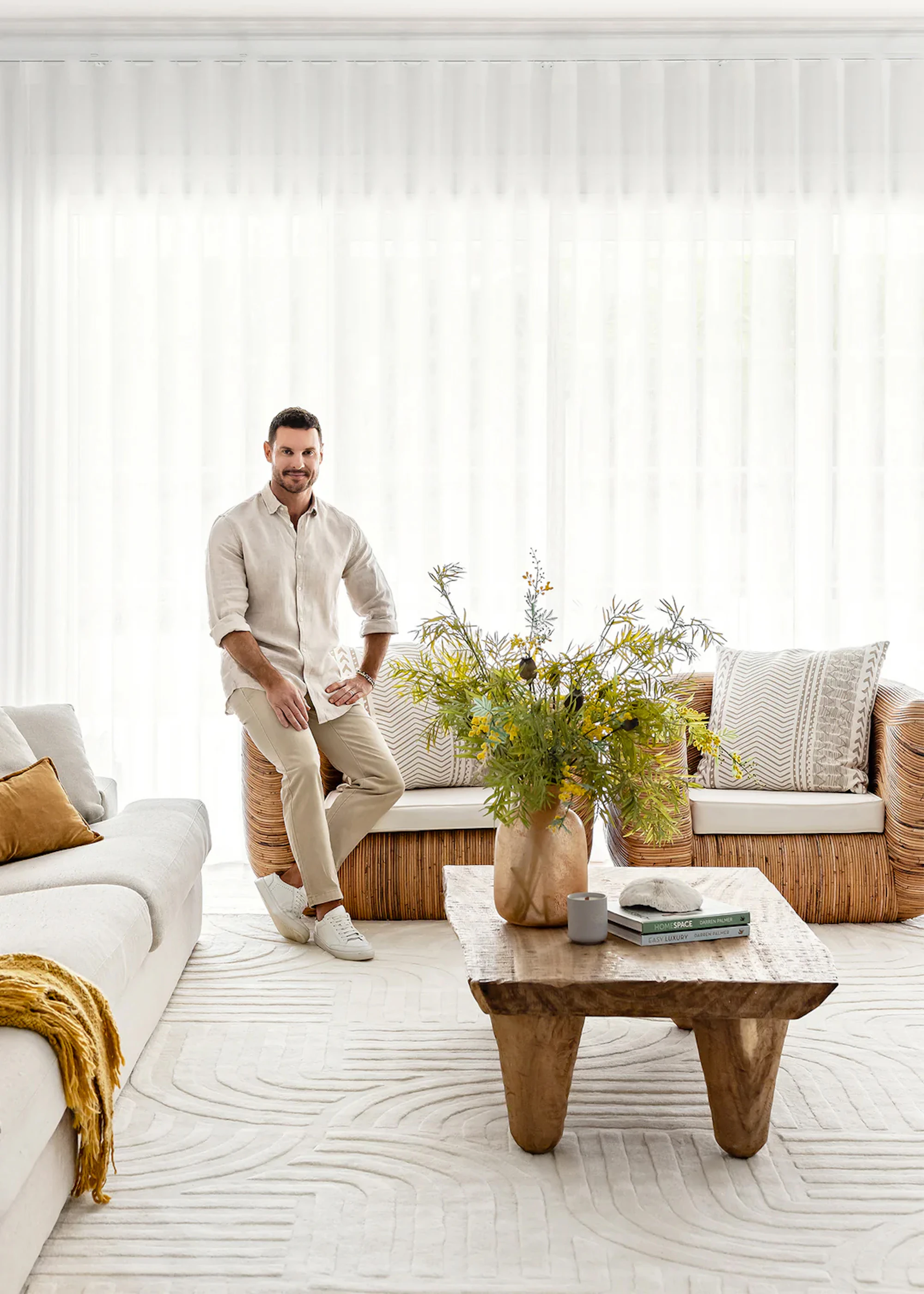 Living room styled with layered sculpted white rug, textured cushions, and a draped throw, showcasing coordinated living room decor ideas for a cohesive and inviting space