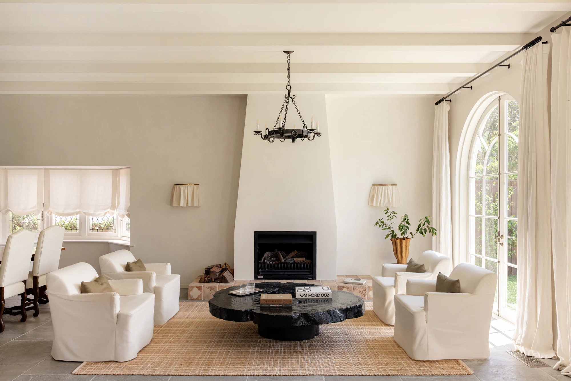 Darren Palmer Plaid Sandstone rug styled beneath the seating area in a bright living room with white armchairs, a black round coffee table