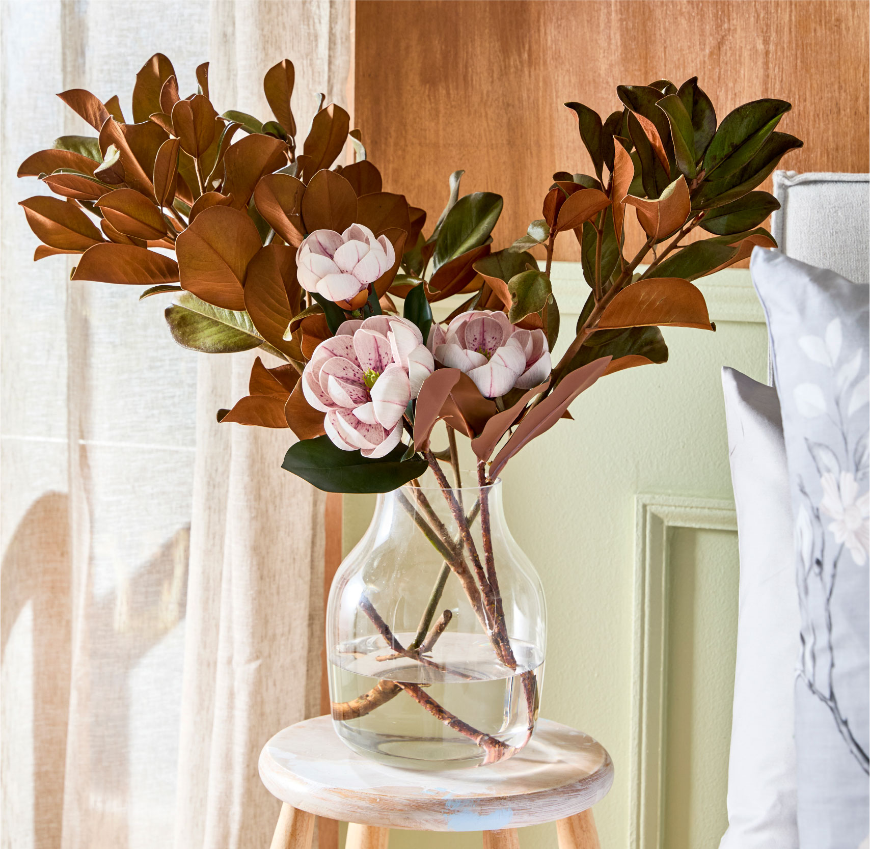 Flowers in a vase on a stool