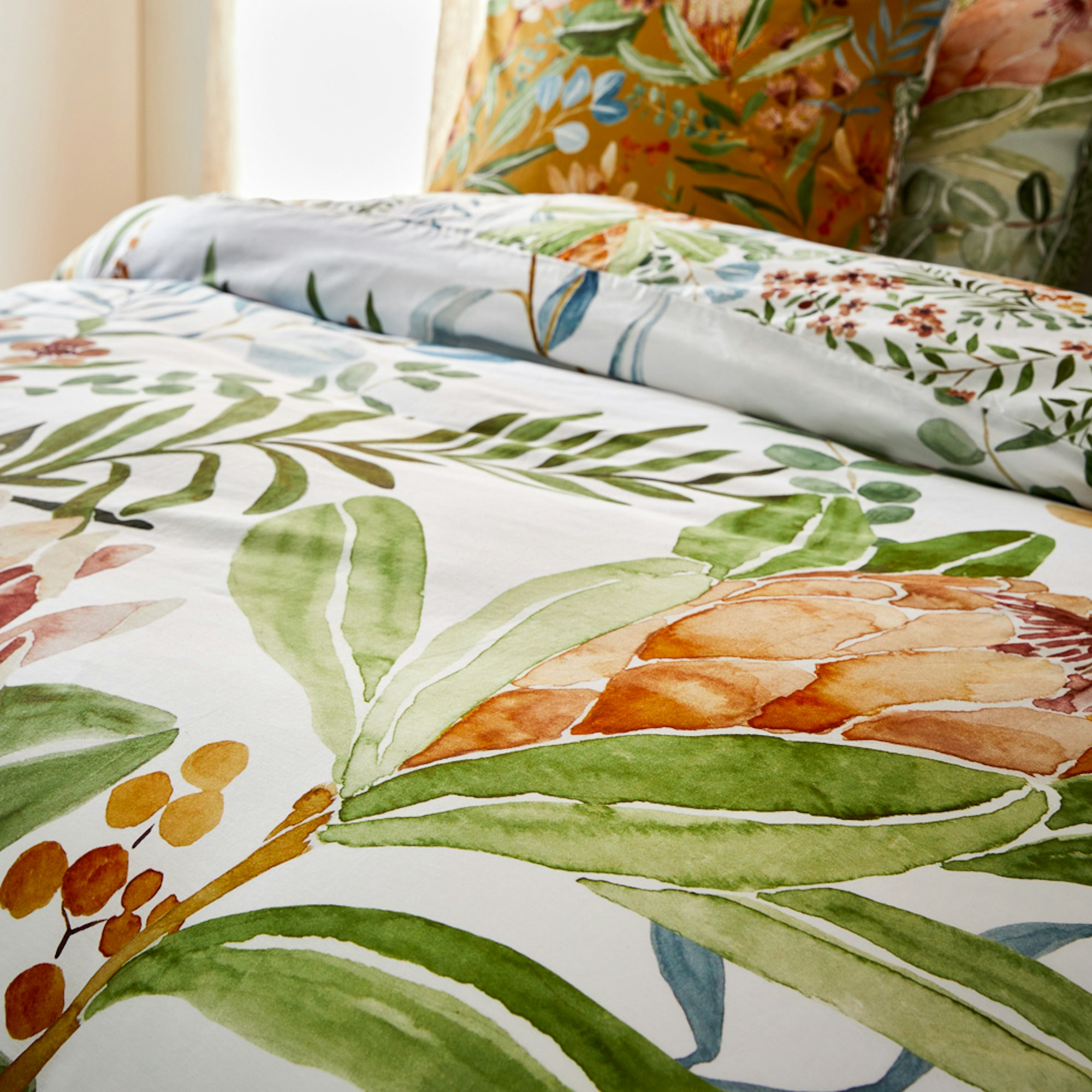 Close up of a white quilt cover with large floral illustrations