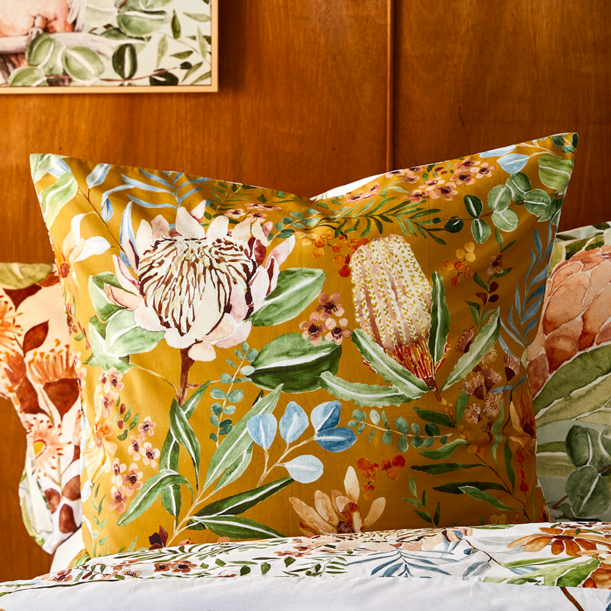 Close up of a dark yellow  European Pillowcase with large floral illustrations