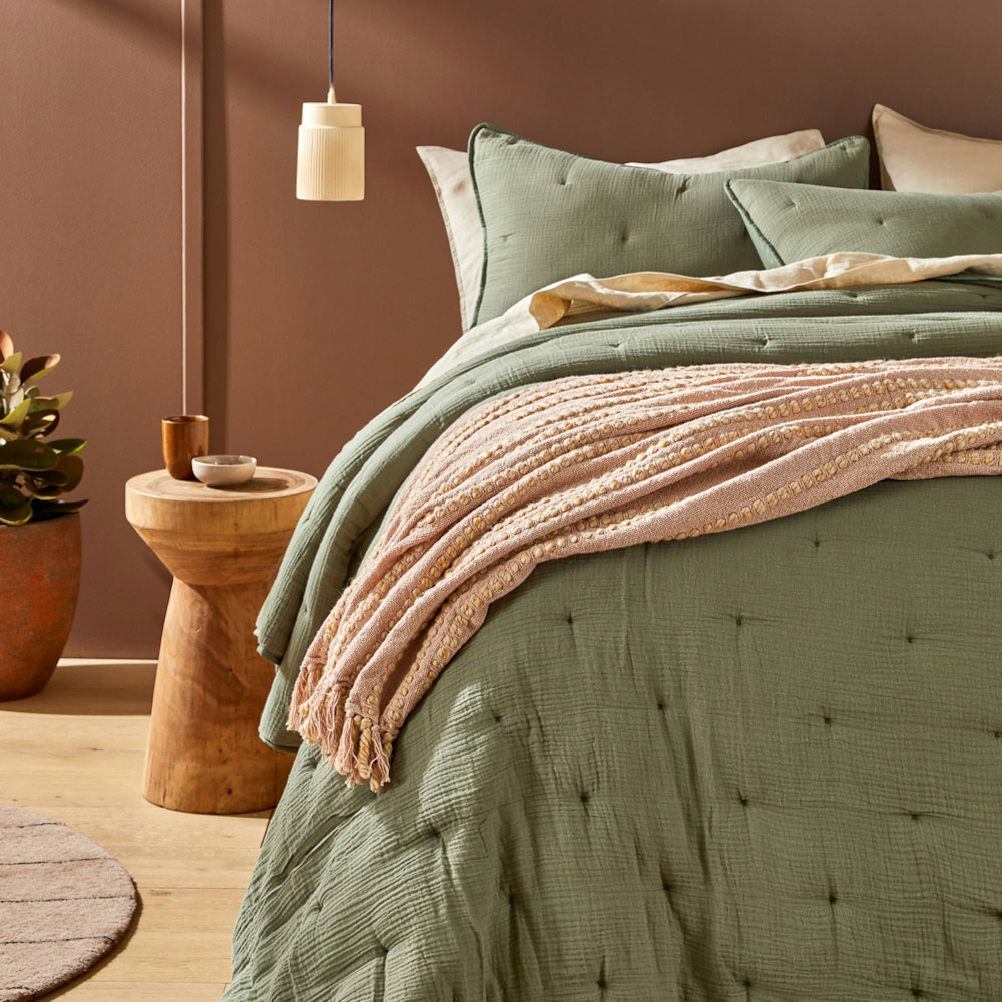 Green coverlet in muslin - How to style your bed for better sleep blog