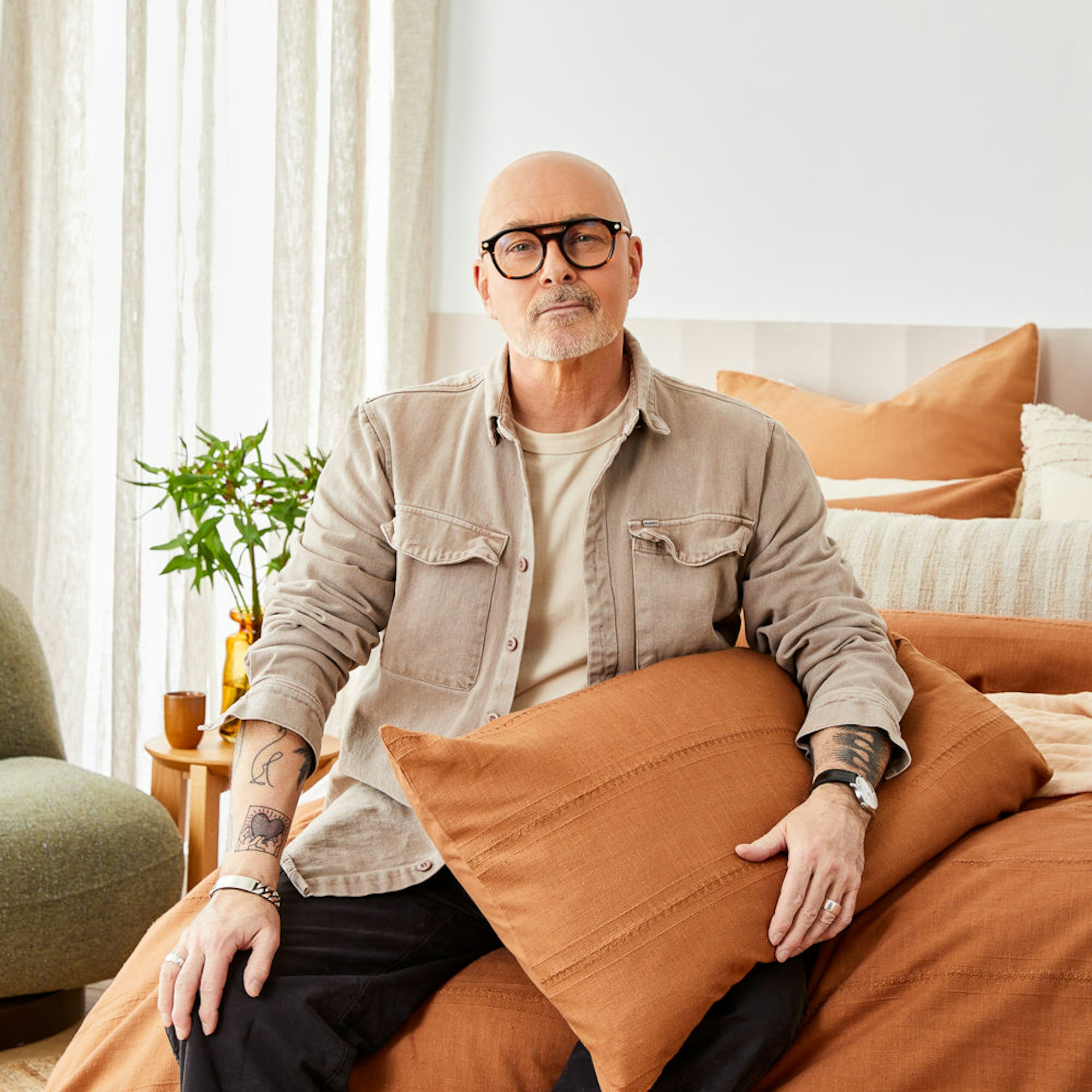 Neale Whitaker holding a pillow sitting